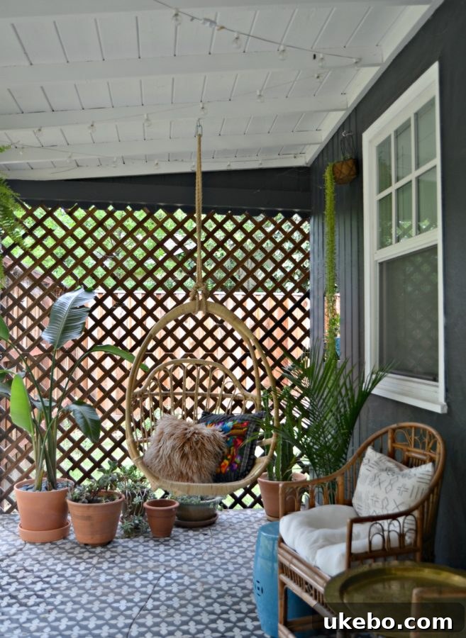 A beautifully styled boho porch with a hanging chair, various plants, and eclectic decor, offering a cozy outdoor living space.
