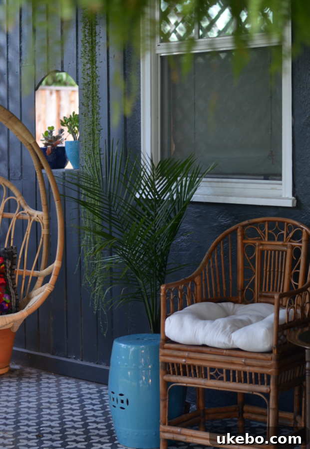 Chic Boho Porch Style Summer 4 A vibrant collection of potted plants, including Boston ferns, adding lush greenery to a bohemian-style porch.