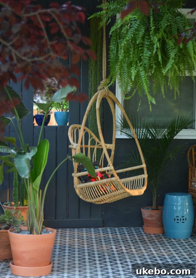 Detail shot of eclectic porch decor, featuring layered textiles, natural elements, and a hint of vintage charm.