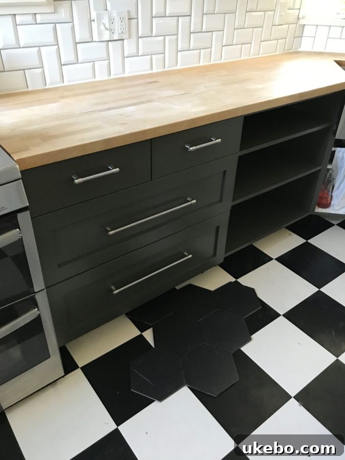 Olive green cabinets with new black floor tiles