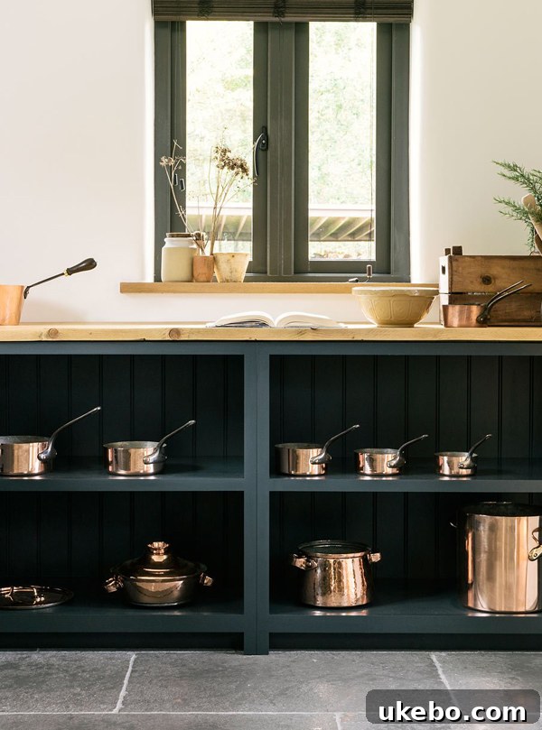Green kitchen design with copper accents
