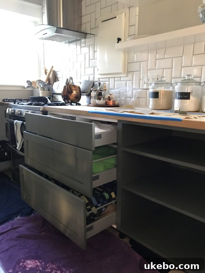 First coat of Dark Olive paint on kitchen cabinet