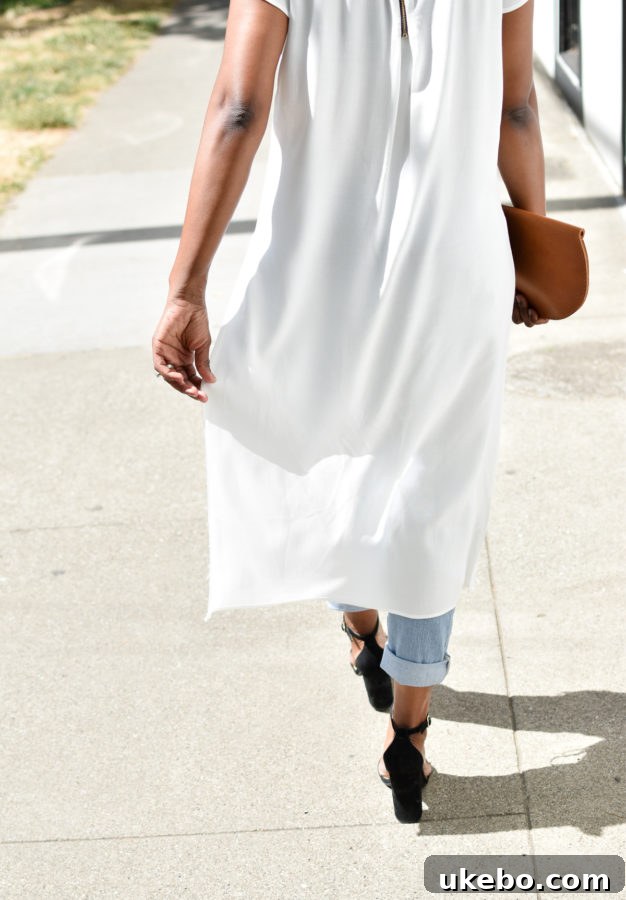 Concluding shot of the outfit, featuring the flowy top and stylish accessories.