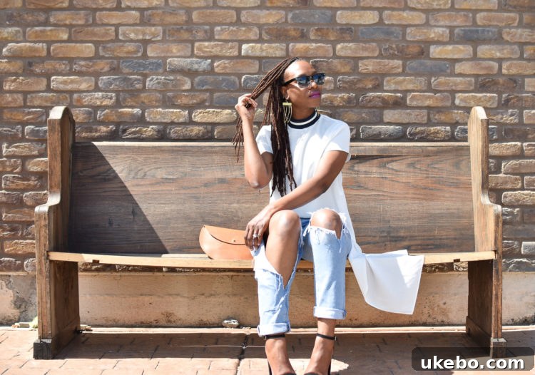 Candid moment capturing the playful spirit of the outfit and the beautiful leather clutch.