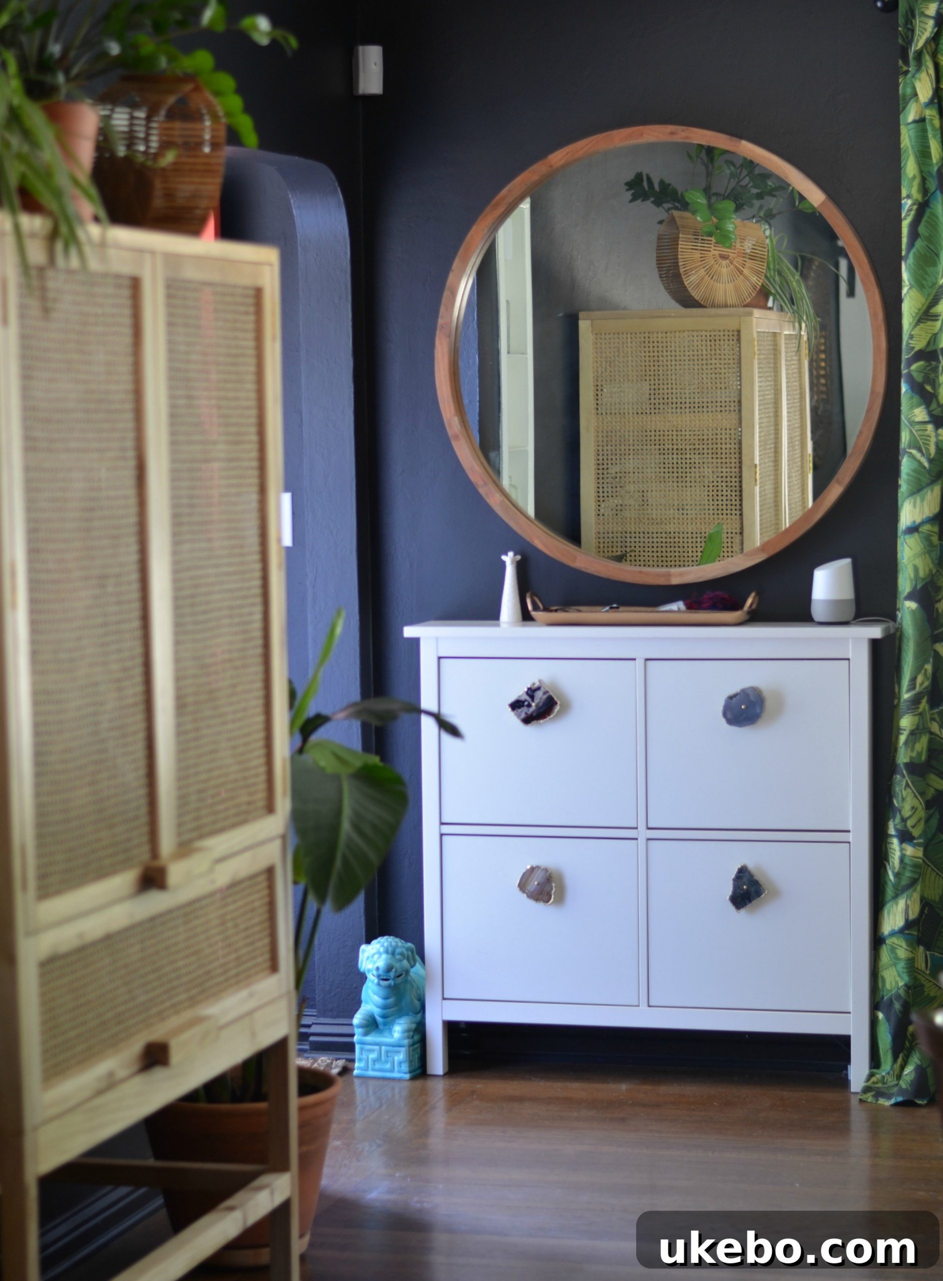 Styling elements on the cabinet surface, including books and decorative objects