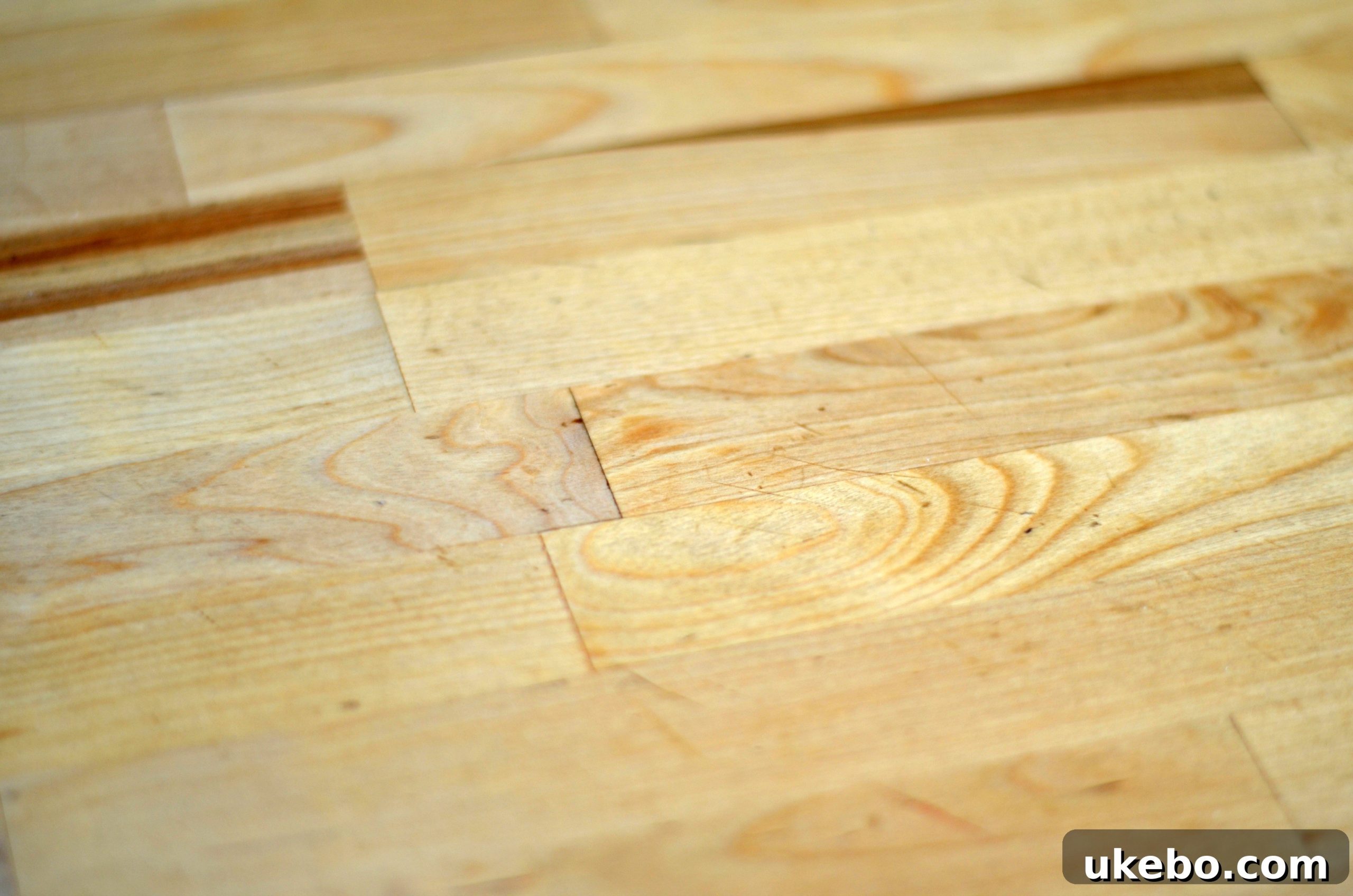 Two images showcasing a well-used butcher block countertop with natural imperfections and a warm tone.