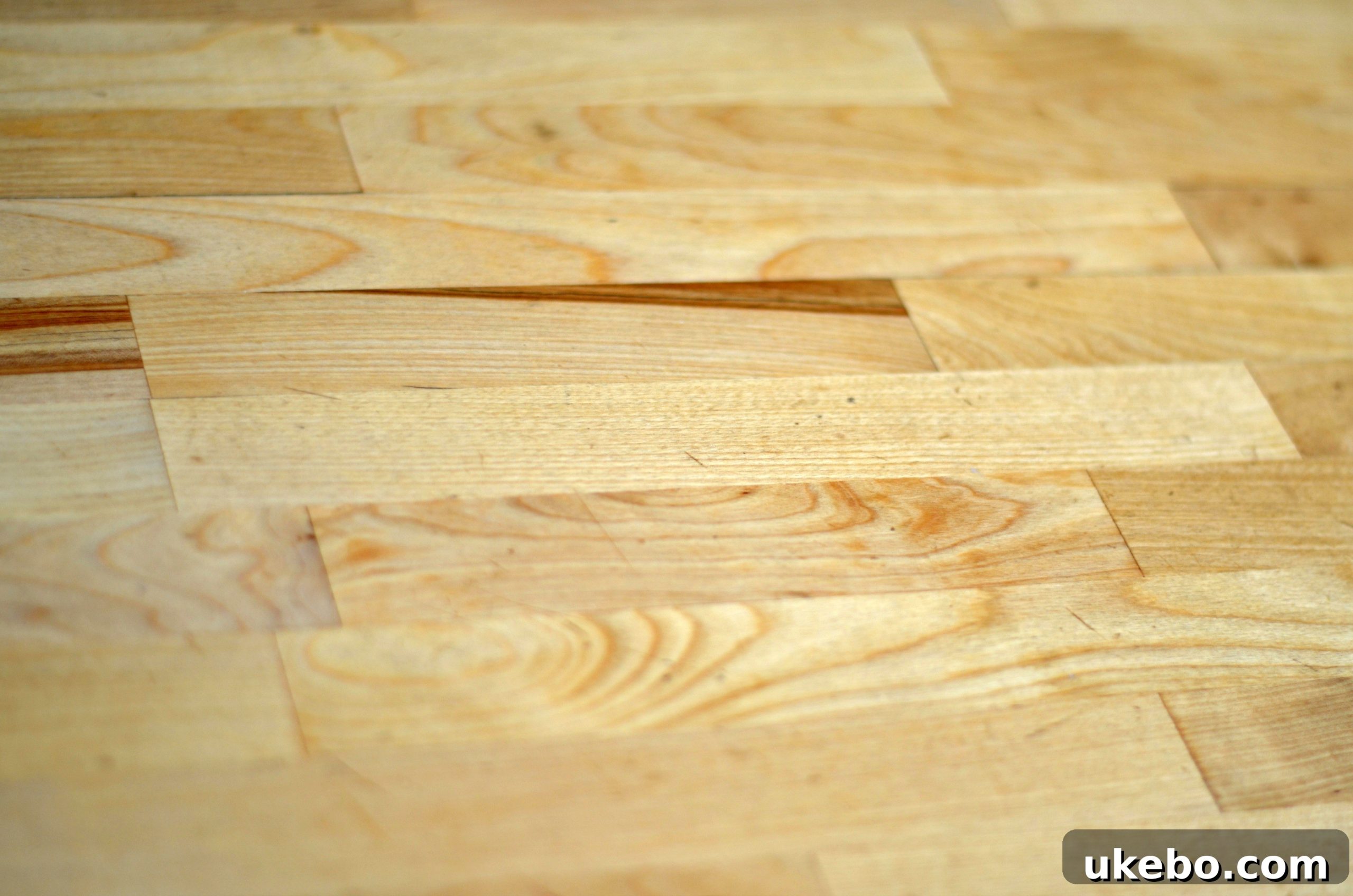 Close-up of a rustic wooden kitchen counter, highlighting the texture and signs of use.