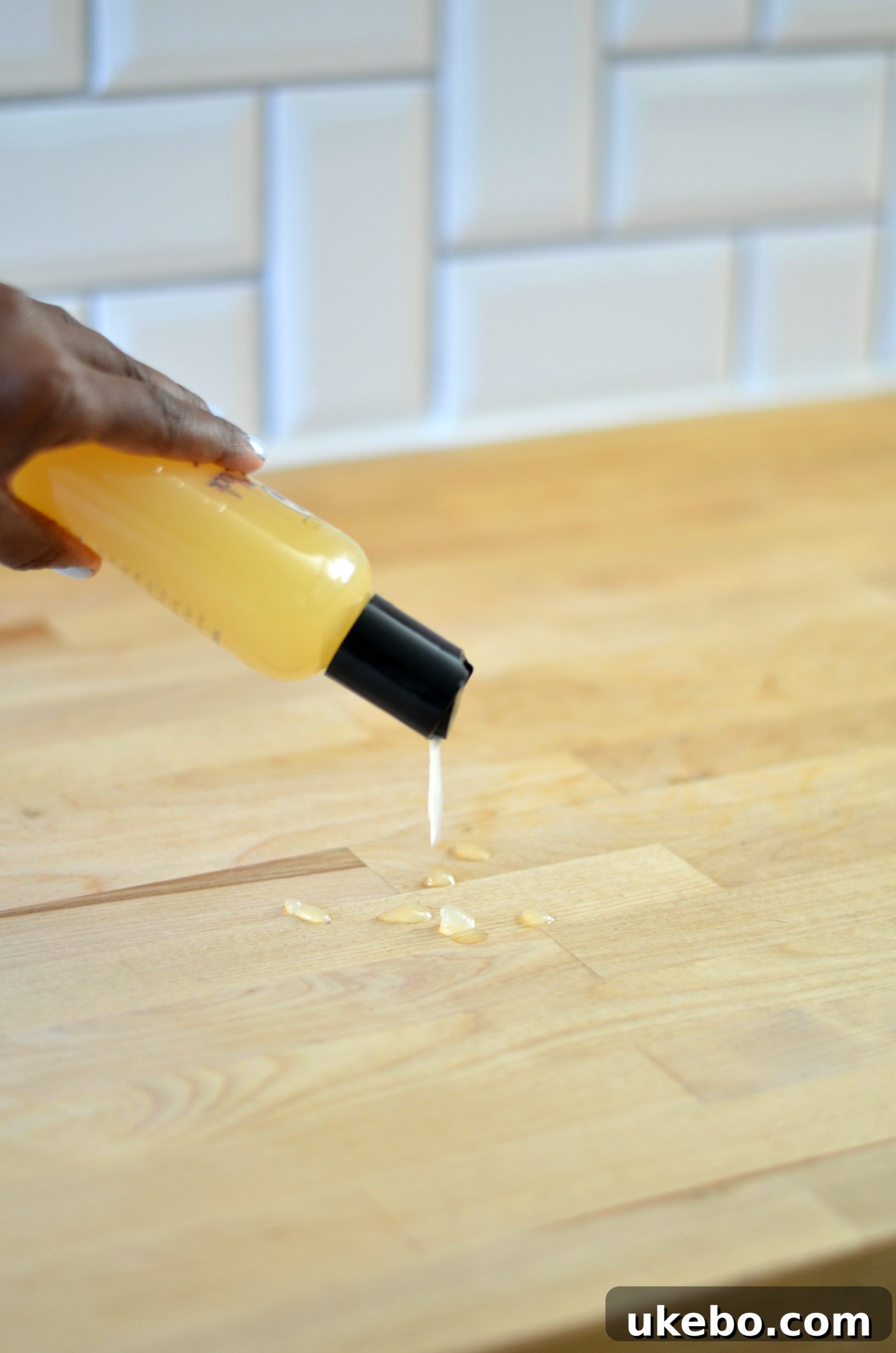 Various images showing the application of wood conditioner to a butcher block countertop.