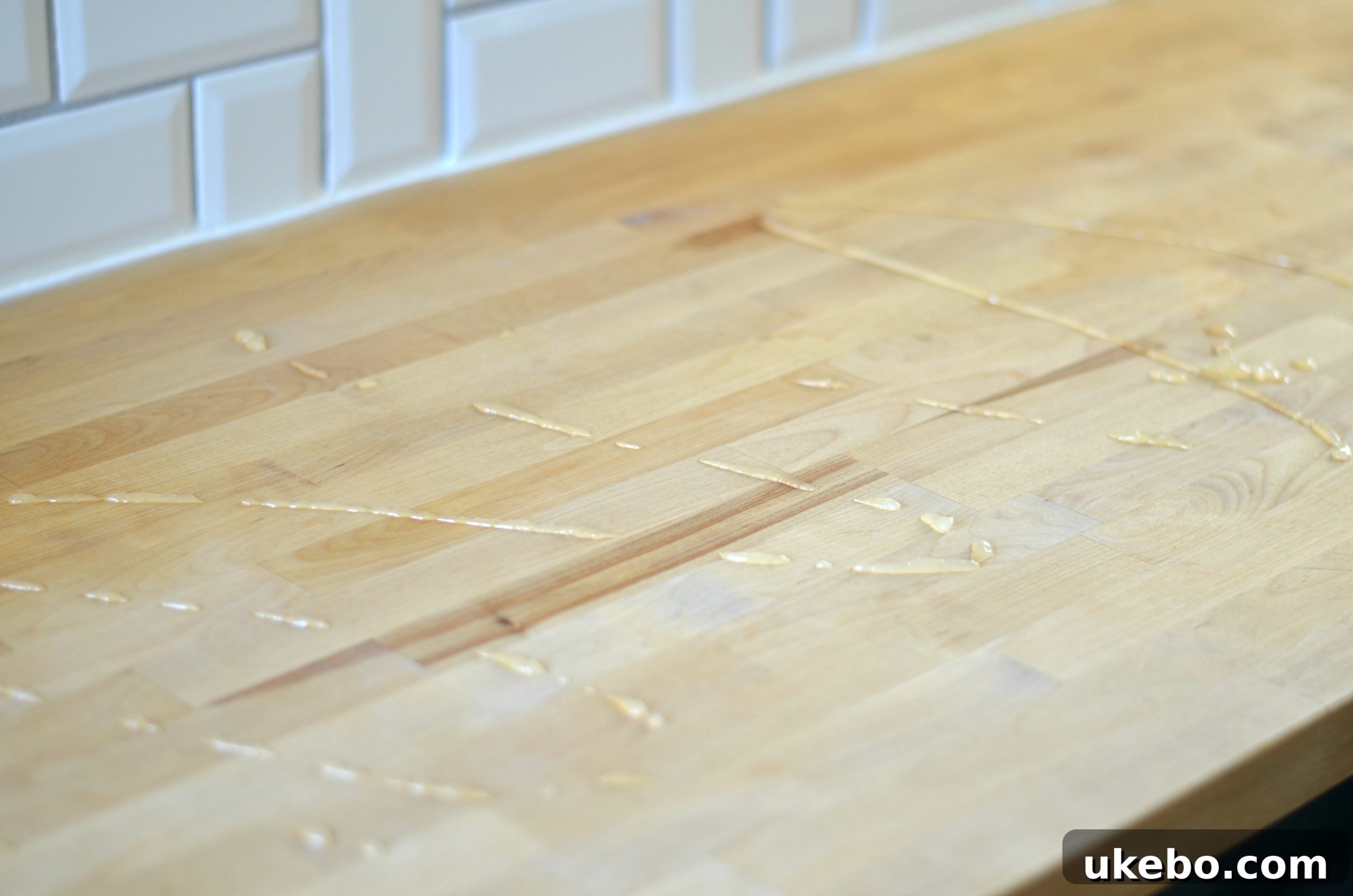 Another perspective of applying conditioner, highlighting the natural wood texture.