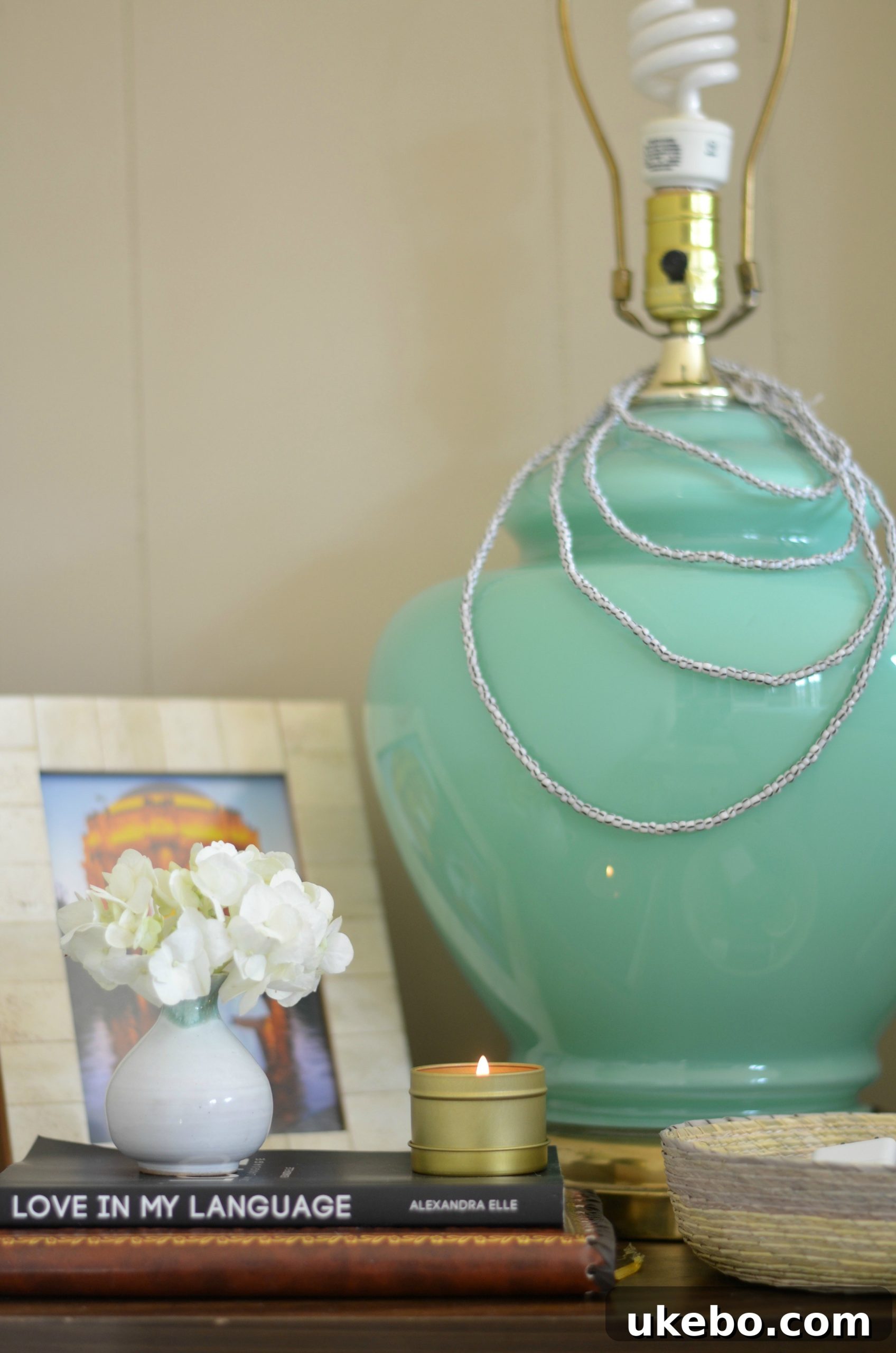Close-up view of the inlay nightstand with the large jade lamp, showcasing the visual imbalance and lack of free surface.