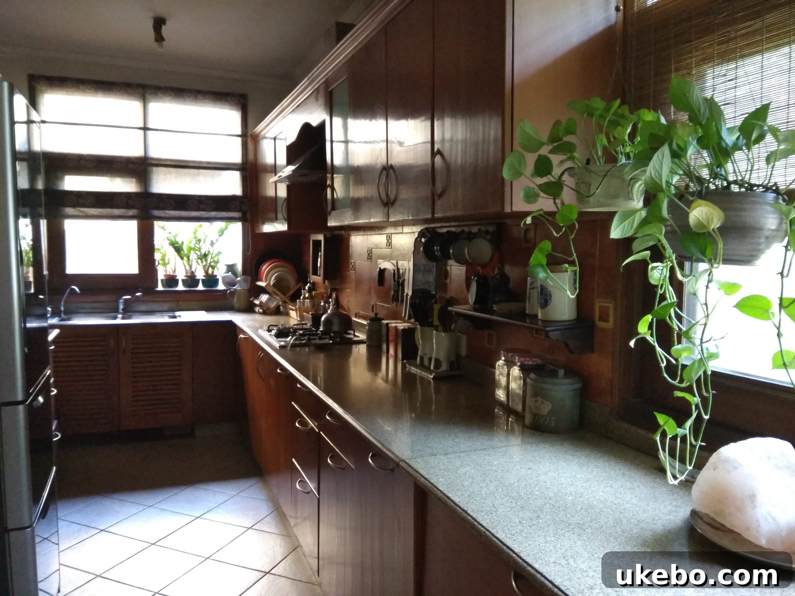 Galley kitchen with washing machine and refrigerator integrated into the design