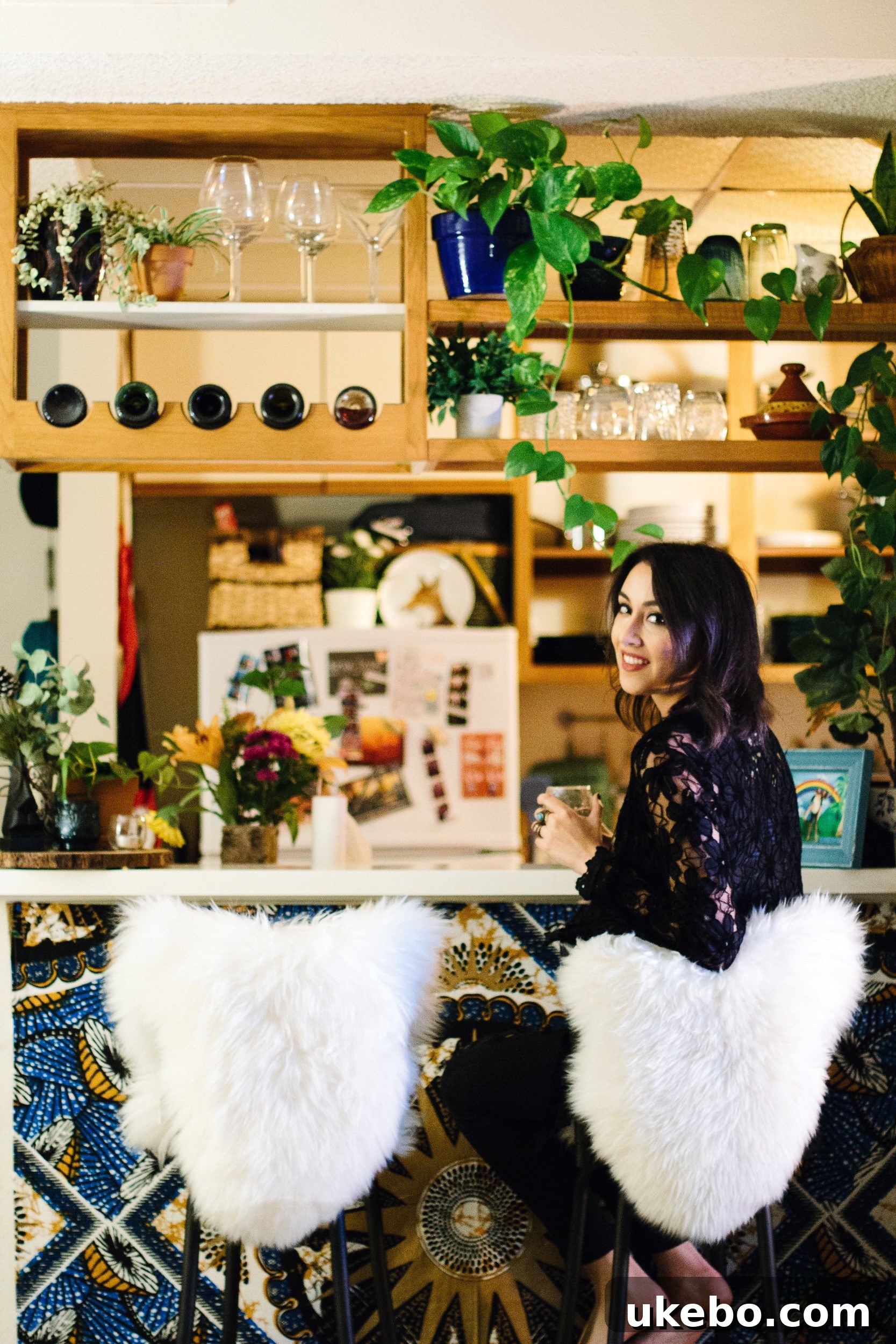 Sara's bohemian living room featuring a cozy sofa, layered rugs, and natural decor