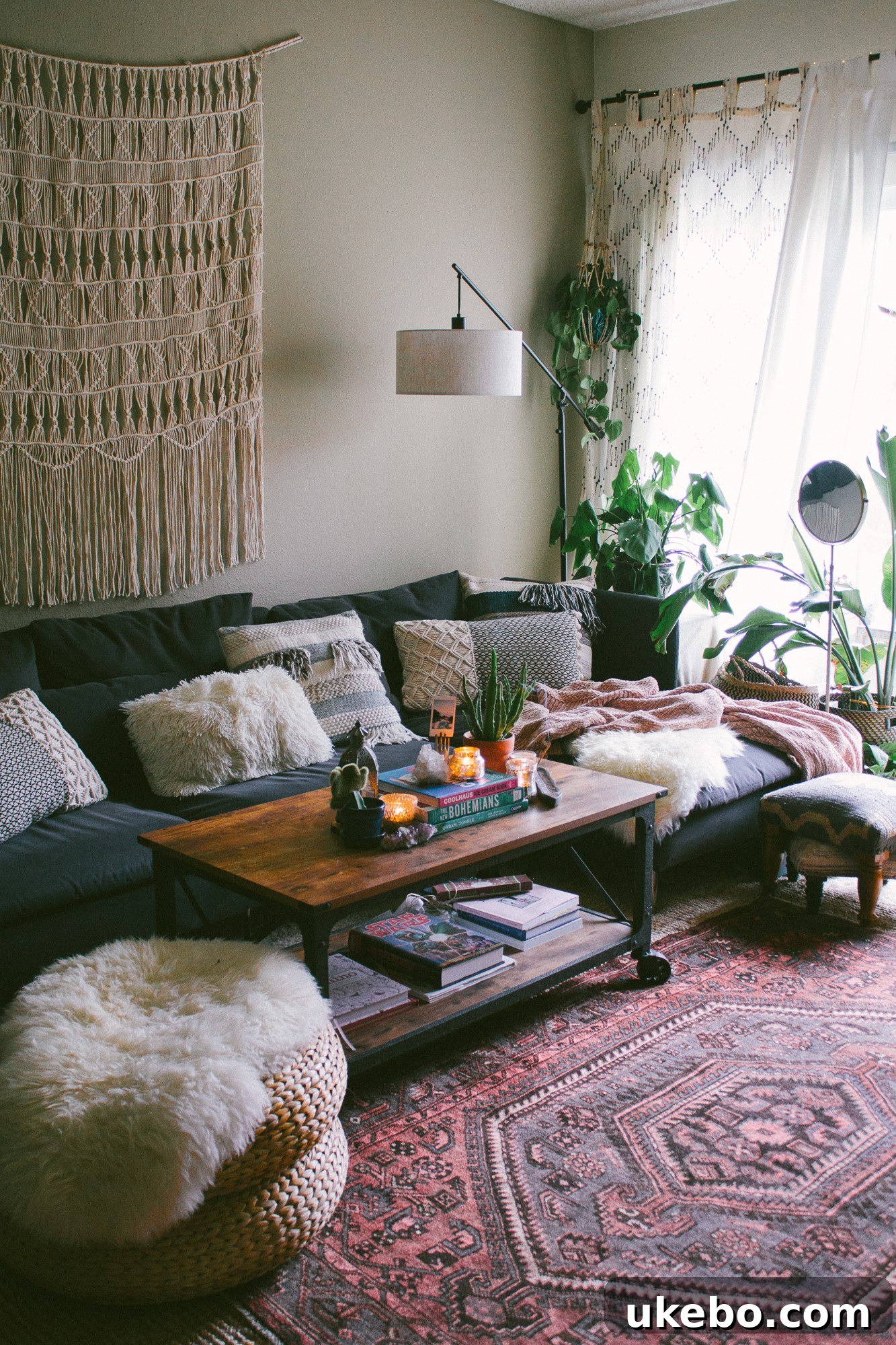 Cozy living room view with a fireplace, eclectic decor, and natural light