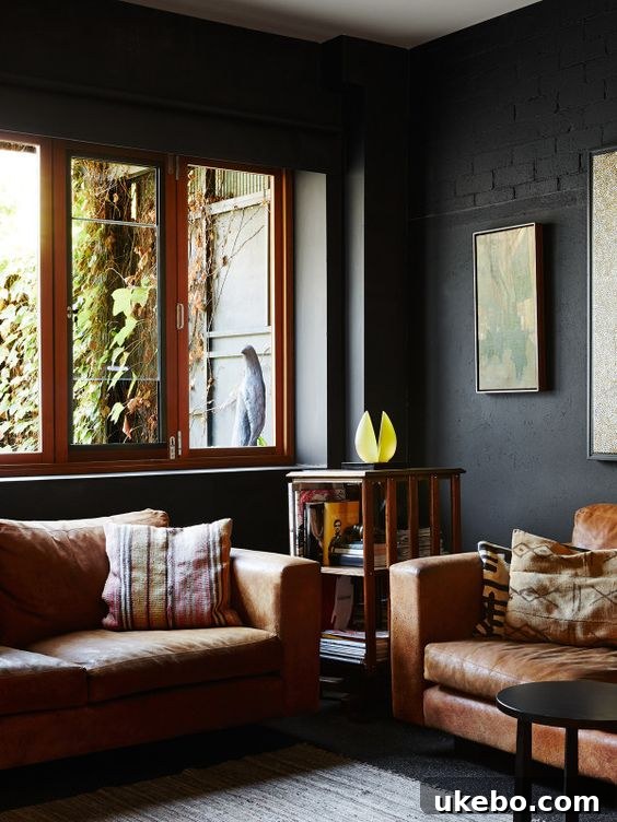 Tan Leather Sofa A Design Muse 2 Modern living room with a sleek tan leather sofa as the centerpiece, complemented by a geometric rug and minimalist decor.
