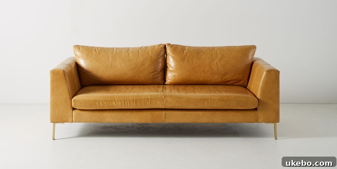Tan Leather Sofa A Design Muse 11 Anthropologie Edlyn Sofa, a beautifully designed piece with elegant curves and a vintage-inspired charm in tan leather.