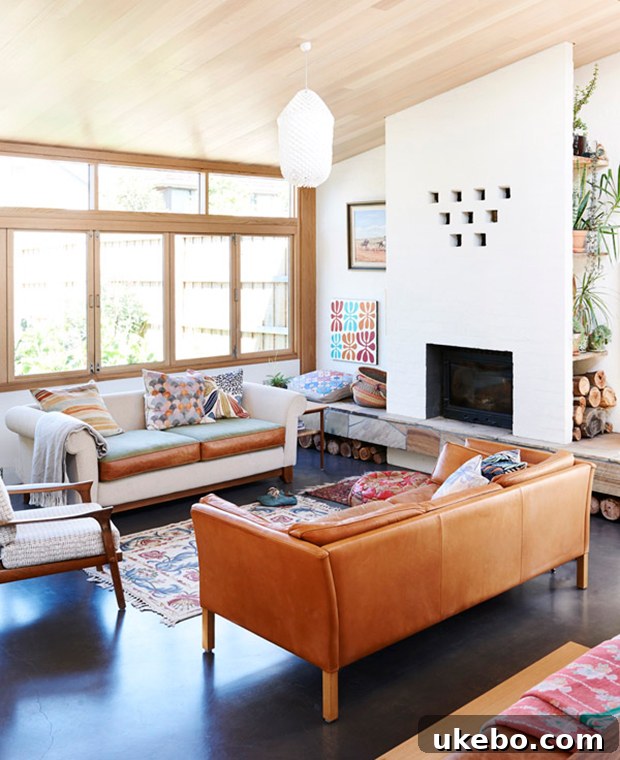 Tan Leather Sofa A Design Muse 5 Bohemian-inspired living space featuring a relaxed tan leather sofa, layered with ethnic patterned pillows and natural elements.