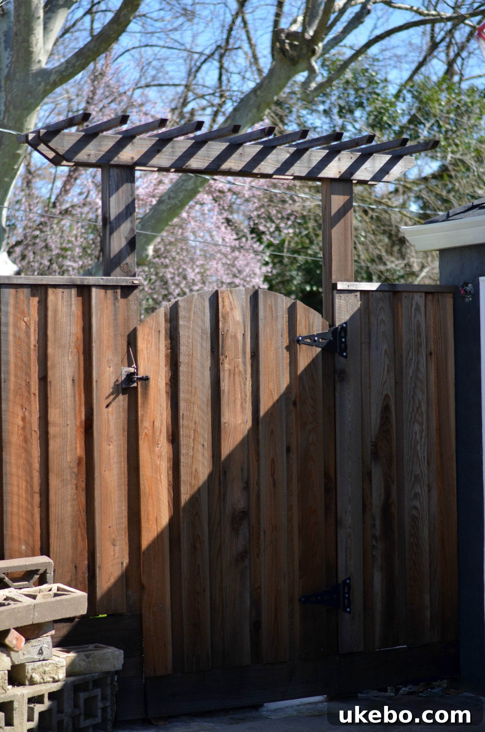 Close-up of the custom redwood arbor and gate, showcasing design details.