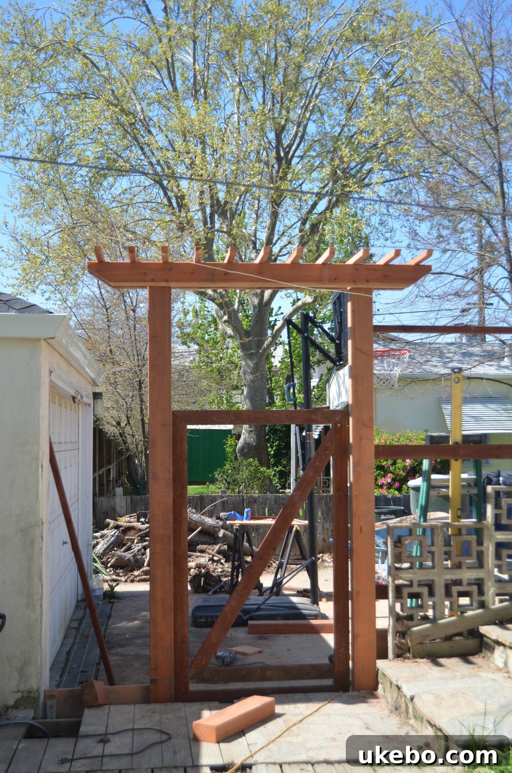 Side view of the impressive redwood gate and arbor, adding architectural interest.