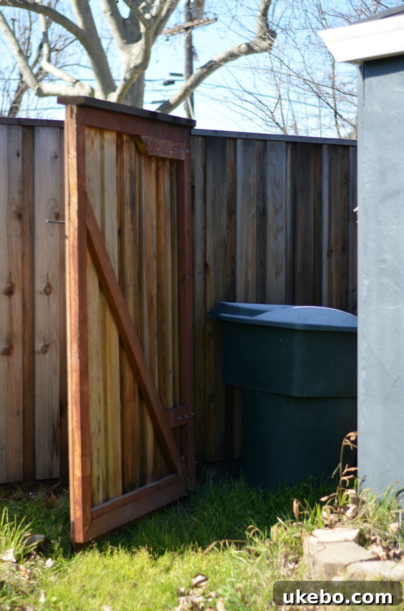 View of the bin storage area from the backyard, showing future concrete slab location.