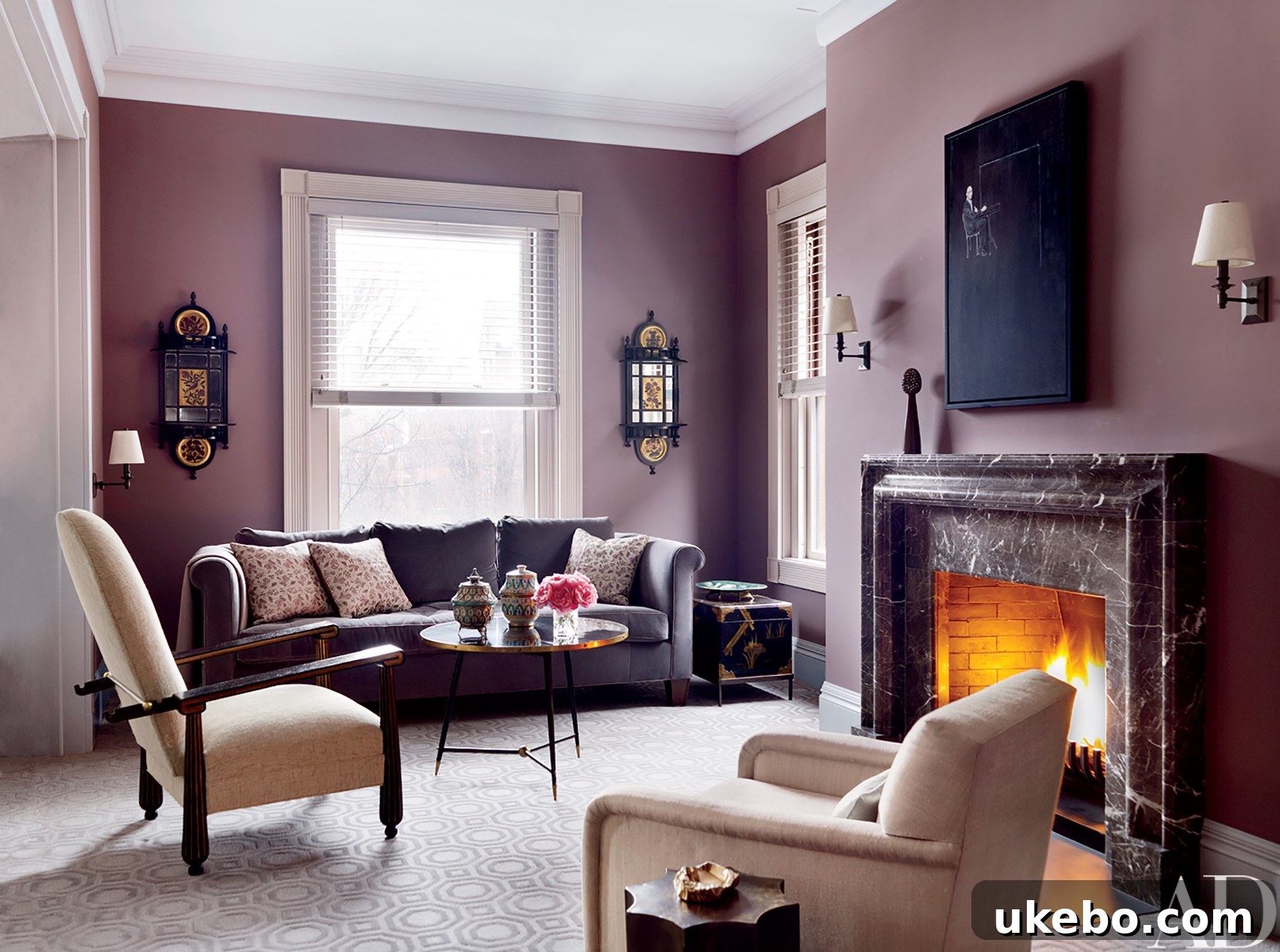 An eclectic and vibrant living area with a prominent purple accent wall, harmonizing with a diverse collection of art and furniture.
