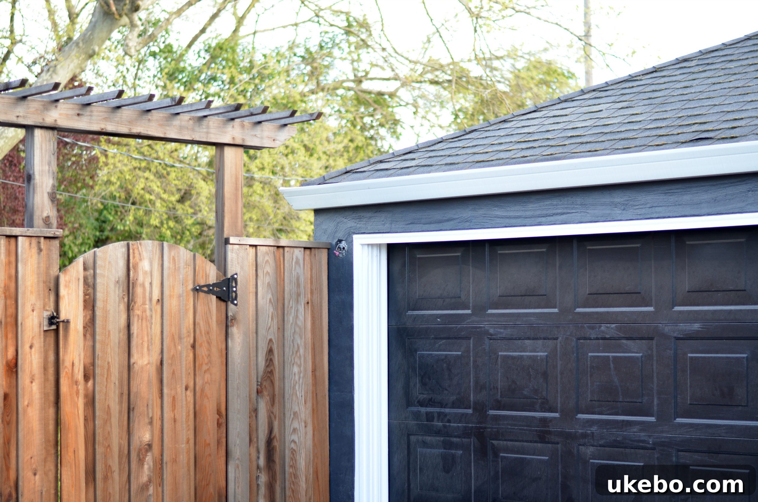 Another view of the empty electrical box on garage wall