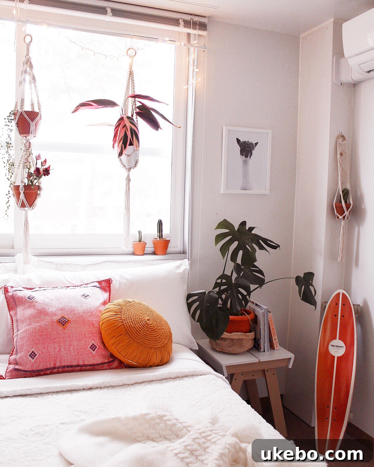 Another perspective of the bedroom, highlighting wall decor and natural light.