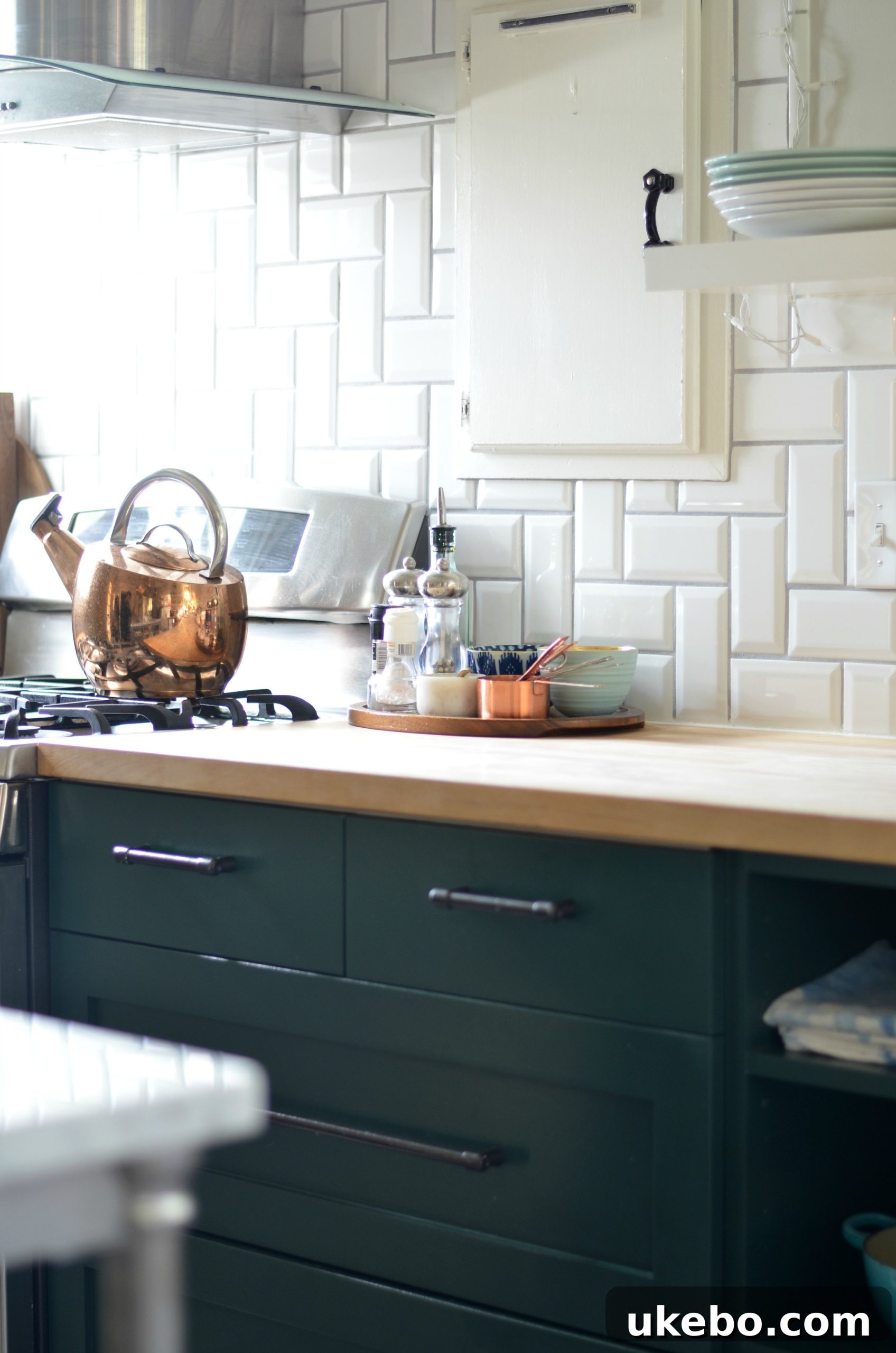 Detailed shot of copper kitchen elements and green cabinets