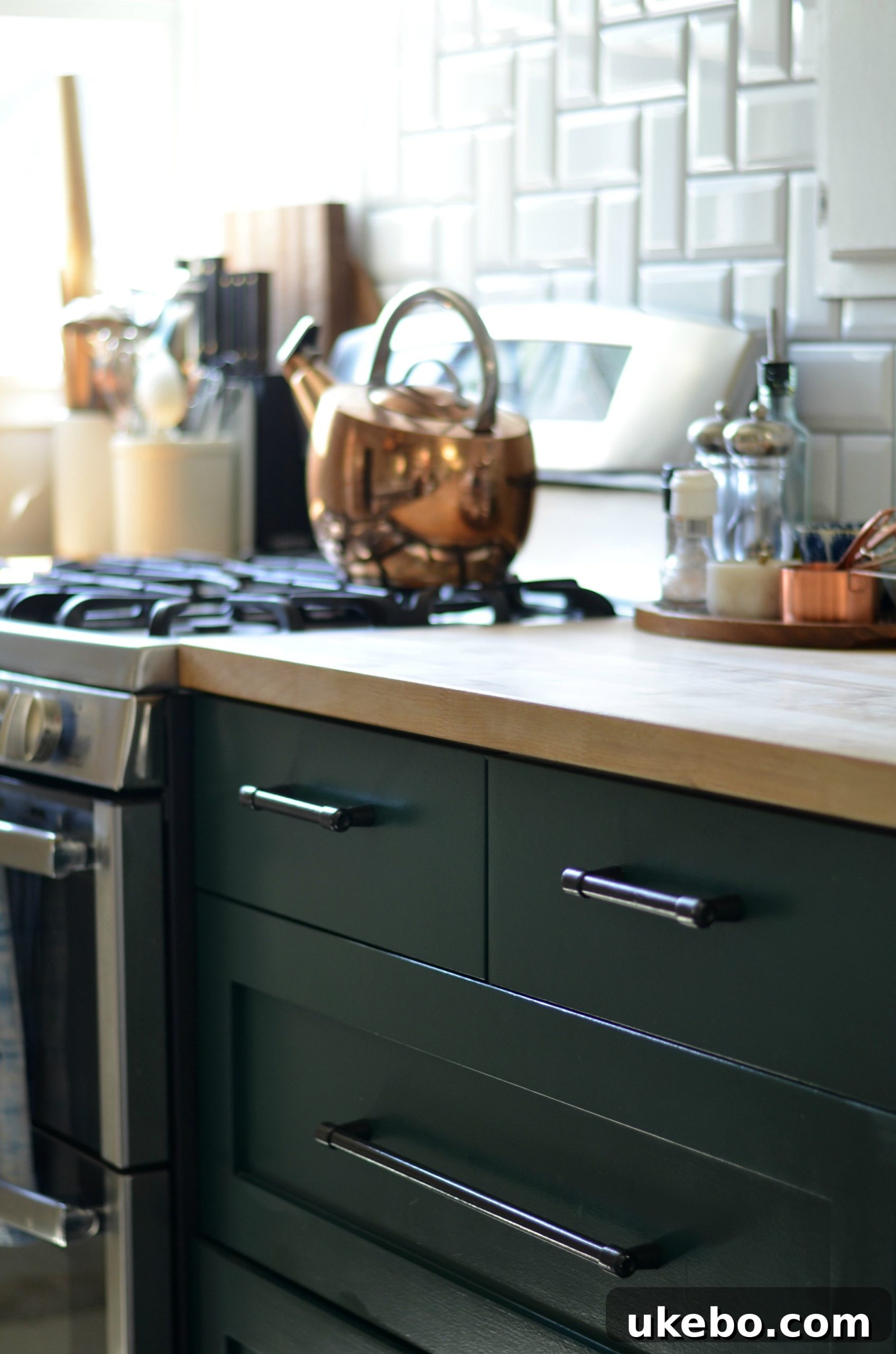 Hunter Green kitchen cabinets reflecting different light, appearing almost black