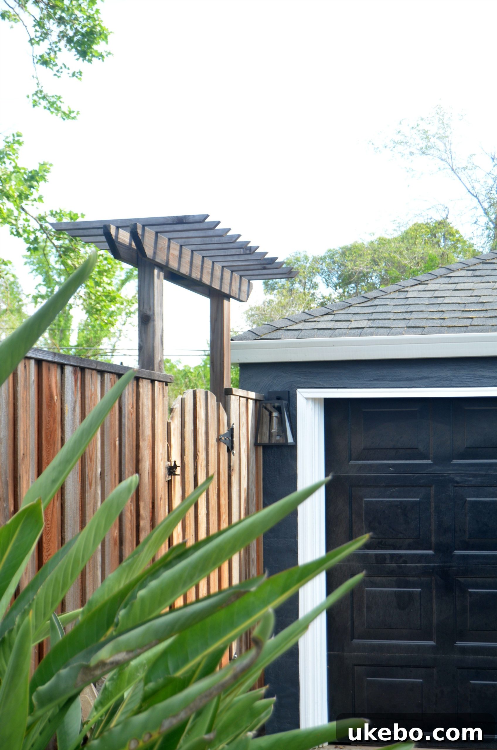 Garage exterior with newly installed Arrington lights and landscaping