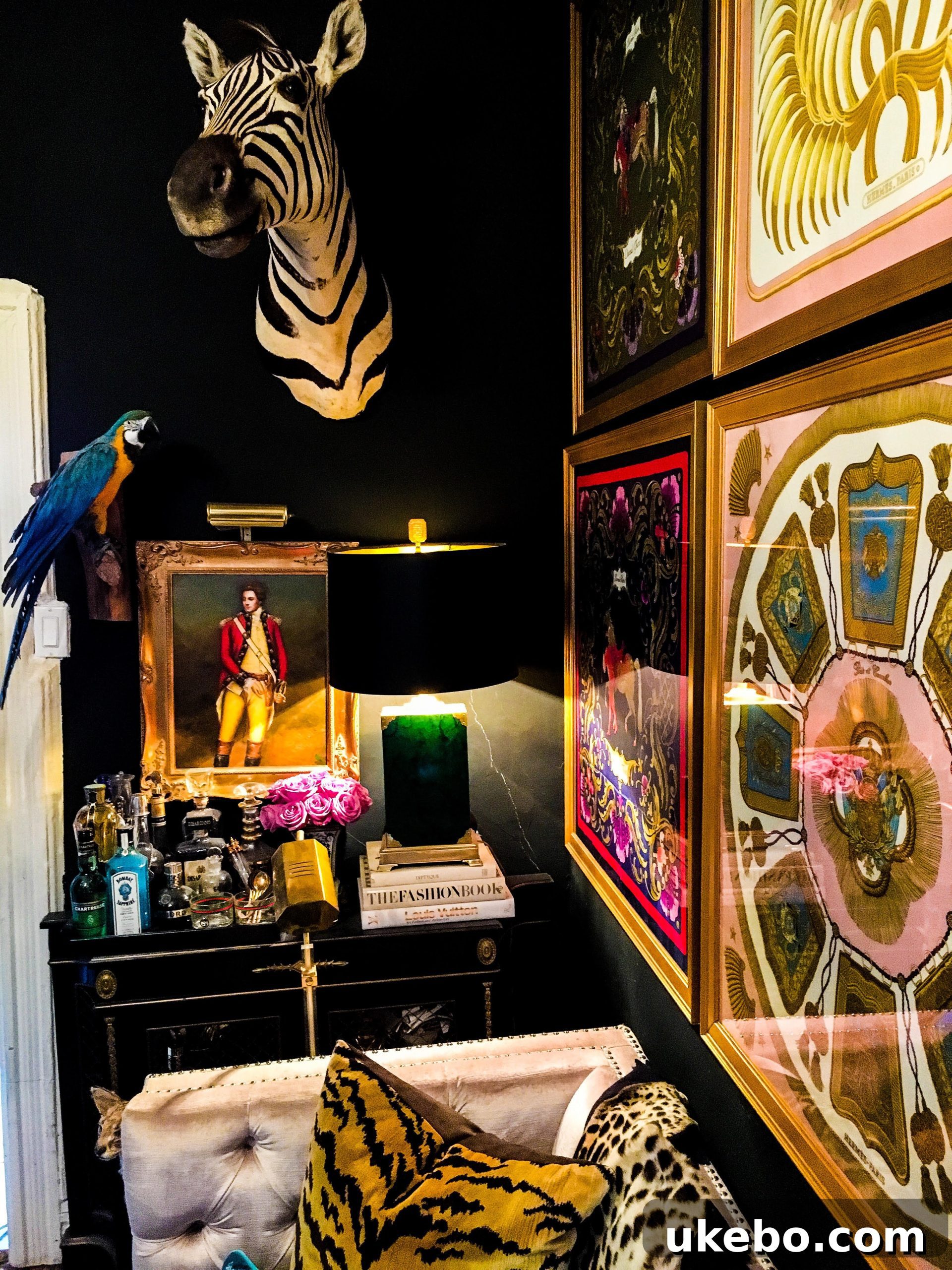 James's eclectic maximalist apartment entry, featuring dark walls, vintage furniture, and unique art installations.