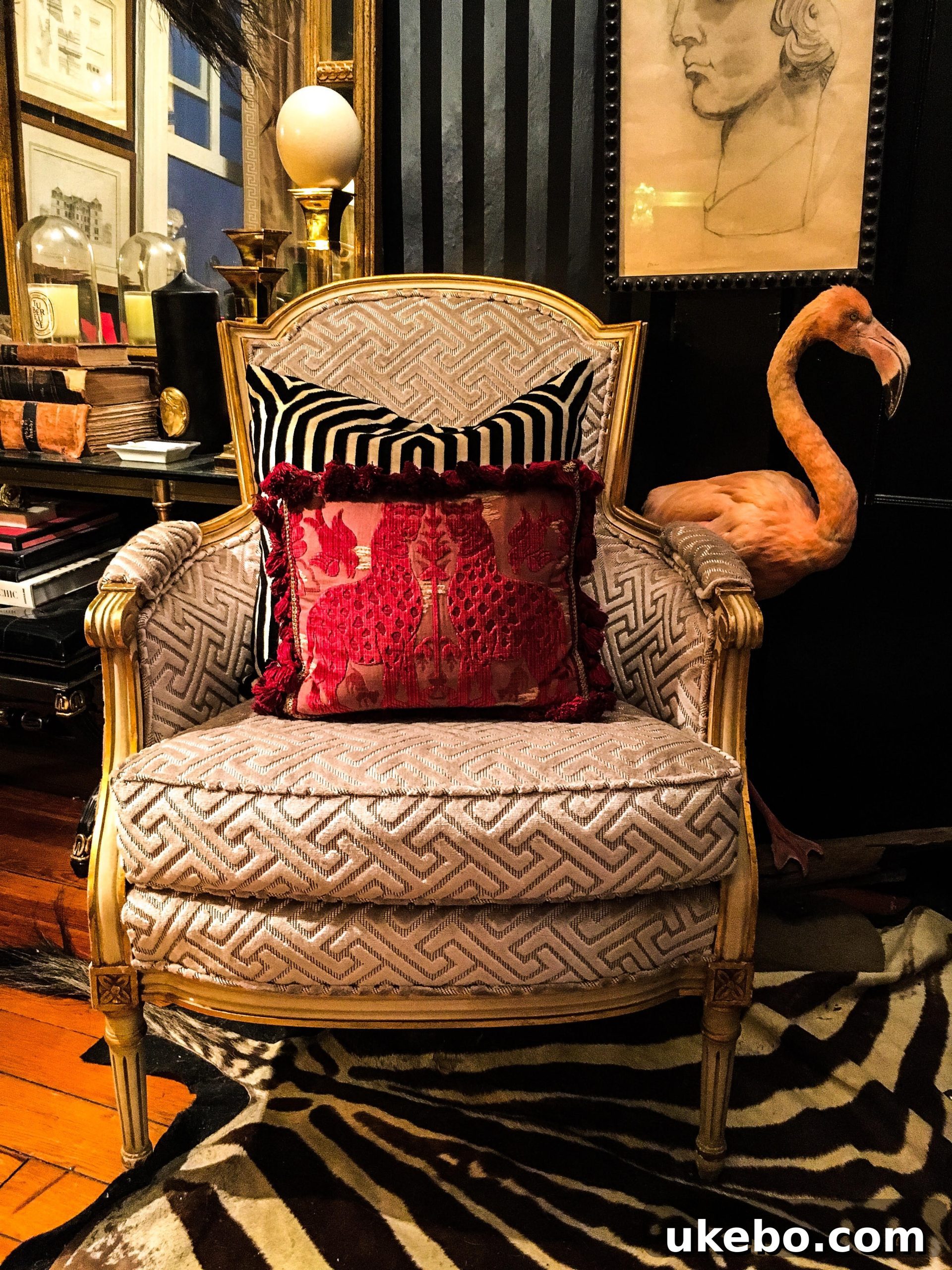 A curated vignette in James's home, displaying an array of collected art objects, vintage furniture, and decorative items that contribute to his maximalist aesthetic.