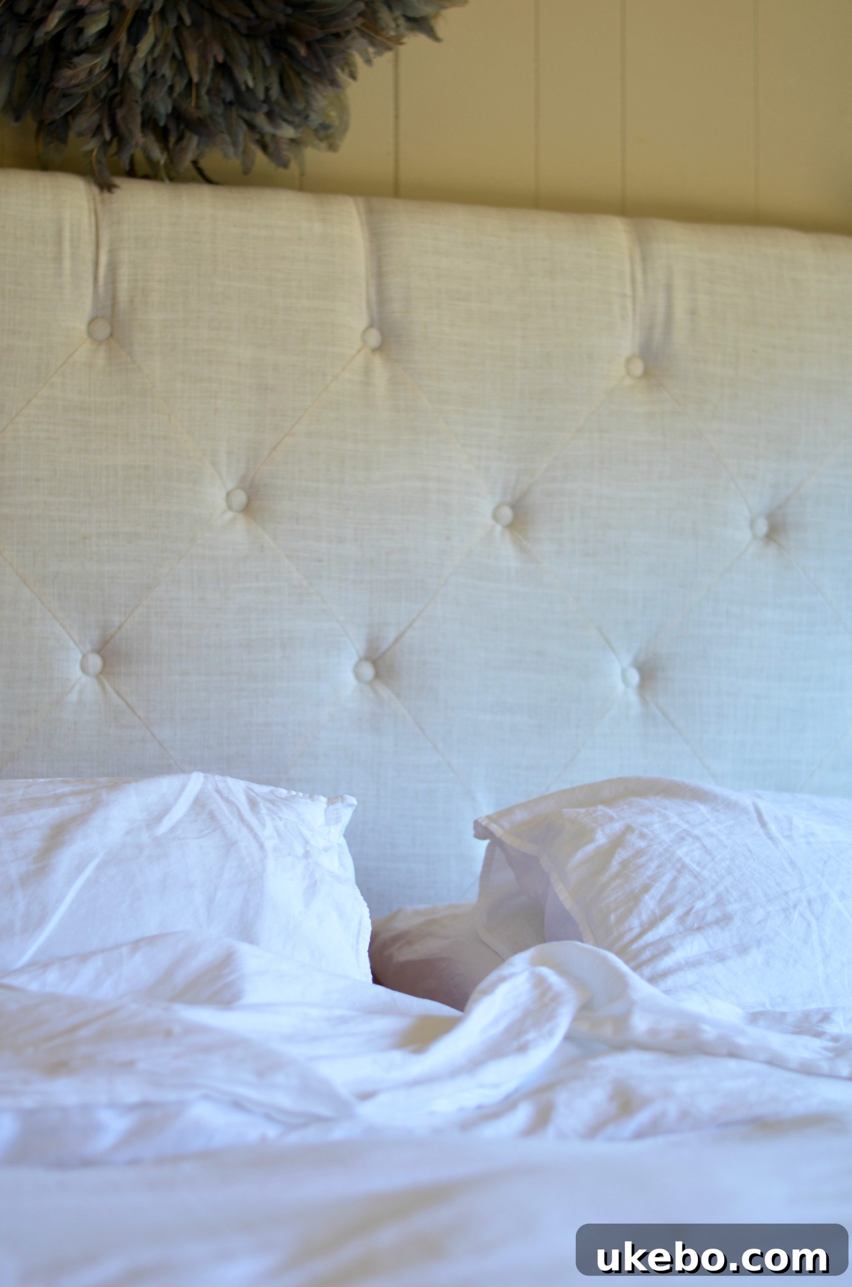 Close-up of the pristine white Ginkova sheets, highlighting their soft texture and inviting appeal.