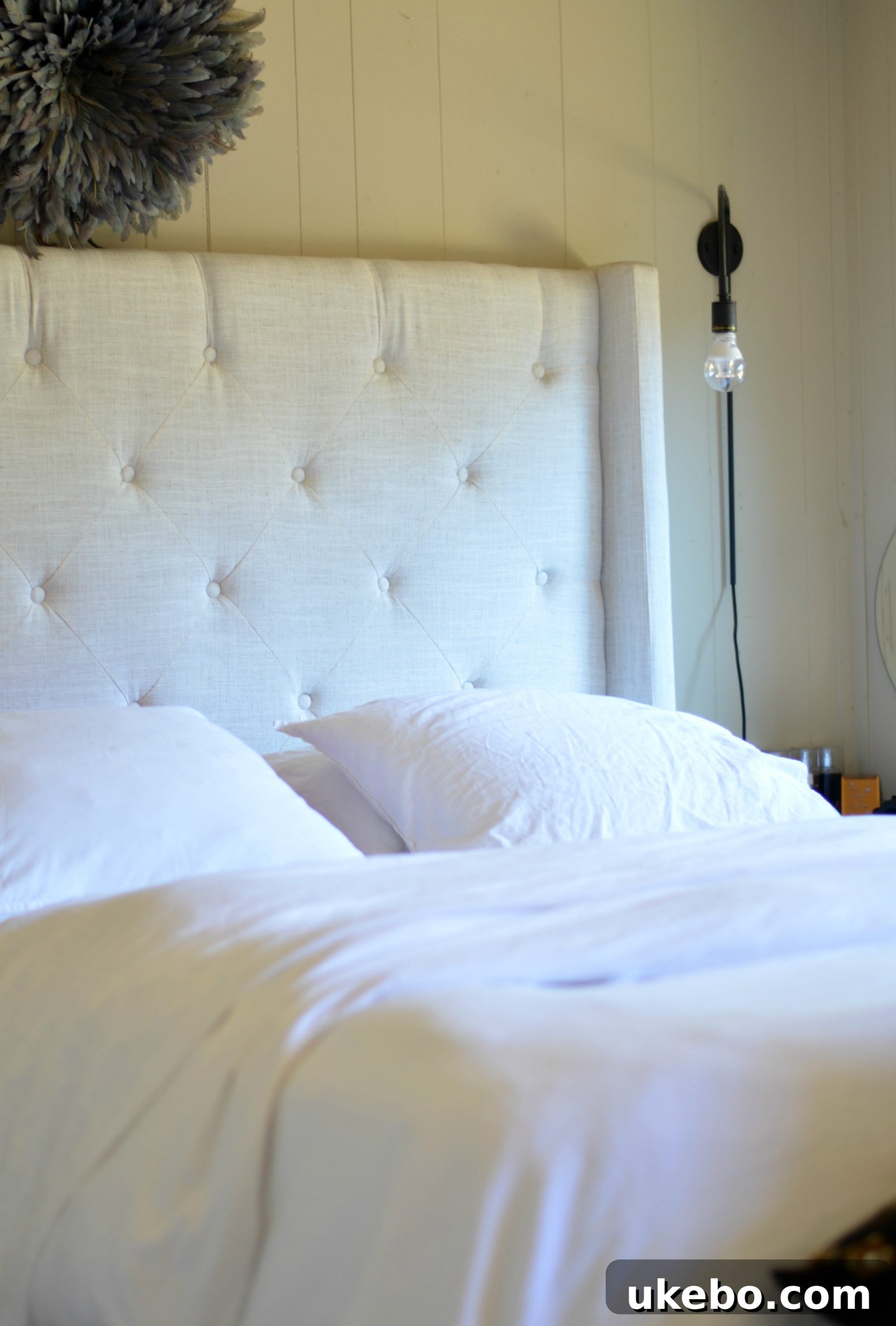 A beautifully made bed with Ginkova bedding, demonstrating its inviting comfort and stylish presence.