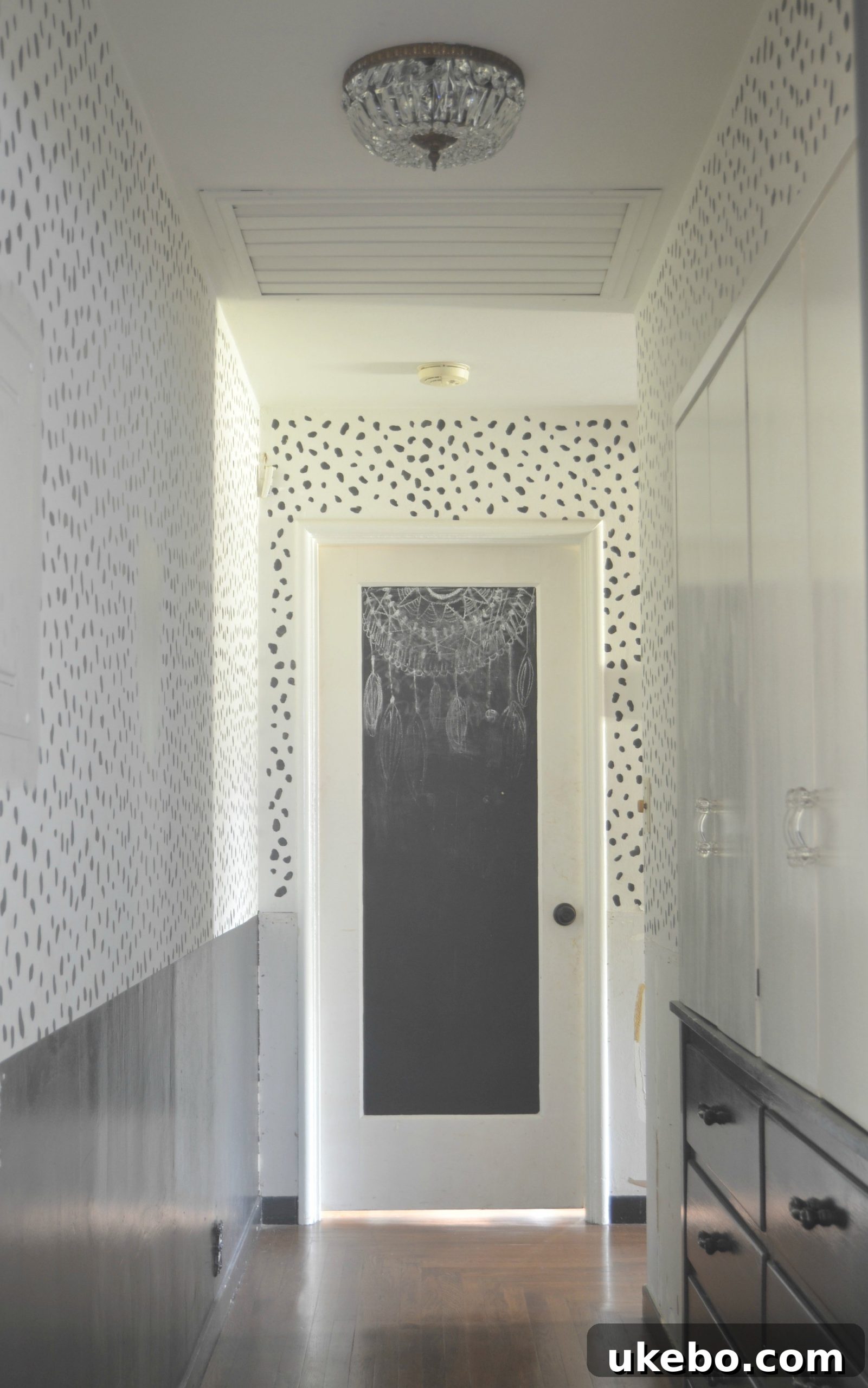 The newly illuminated hallway, showcasing the impact of the vintage flush mount chandeliers on the overall brightness.