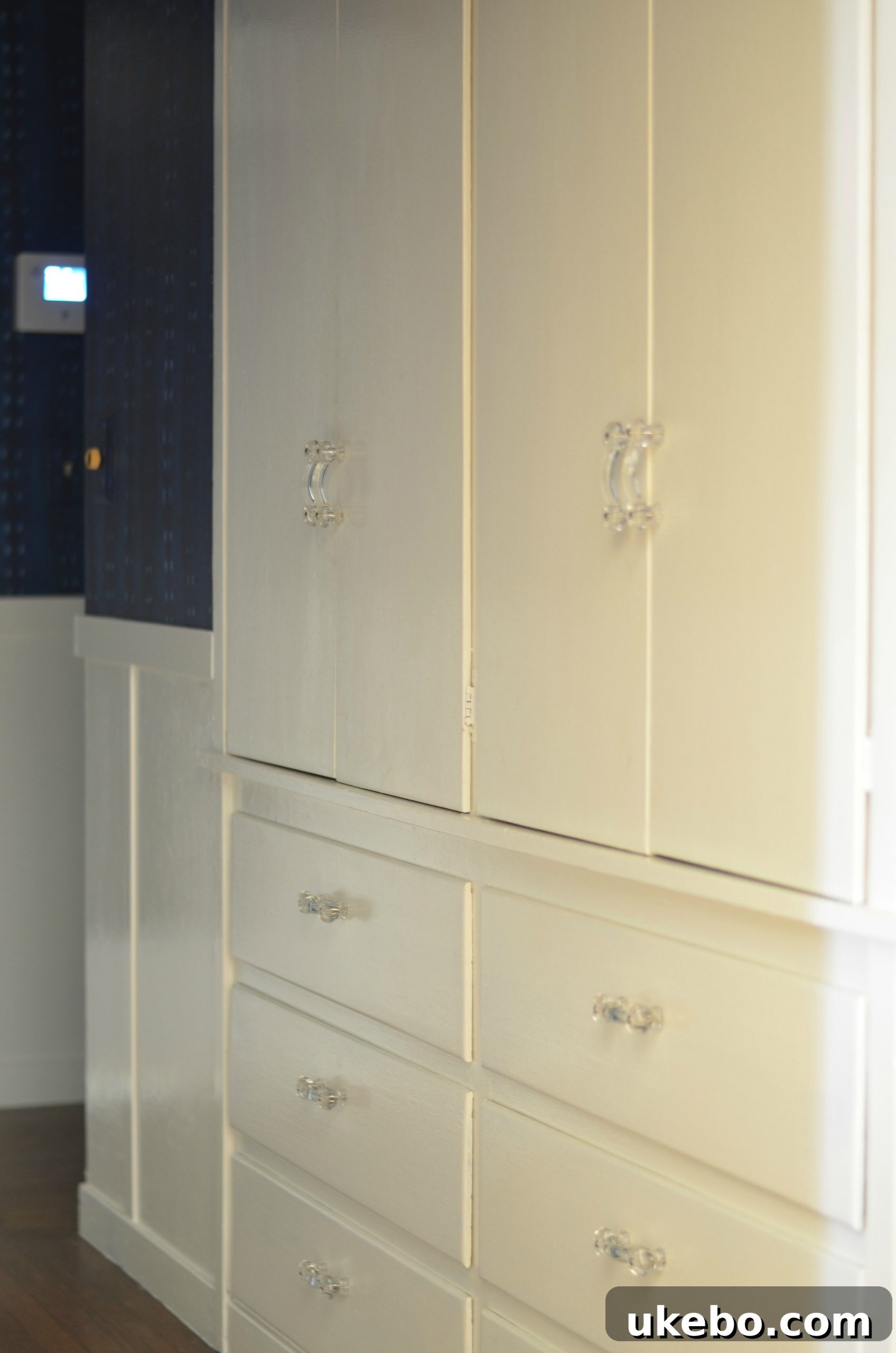 DIY board and batten wainscoting in the hallway, with new clear glass hardware on built-ins