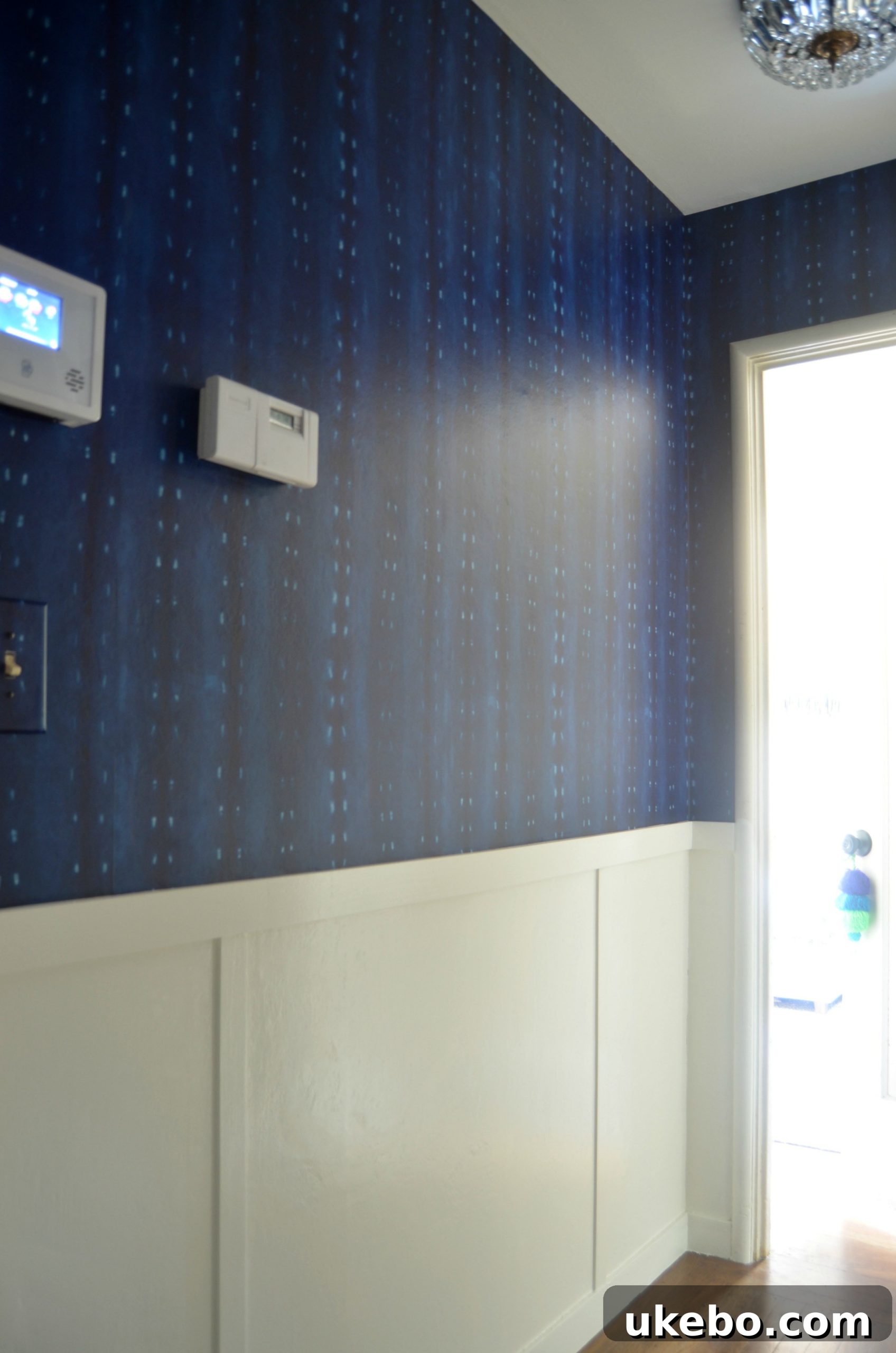 Professional wallpaper installation in the newly renovated hallway