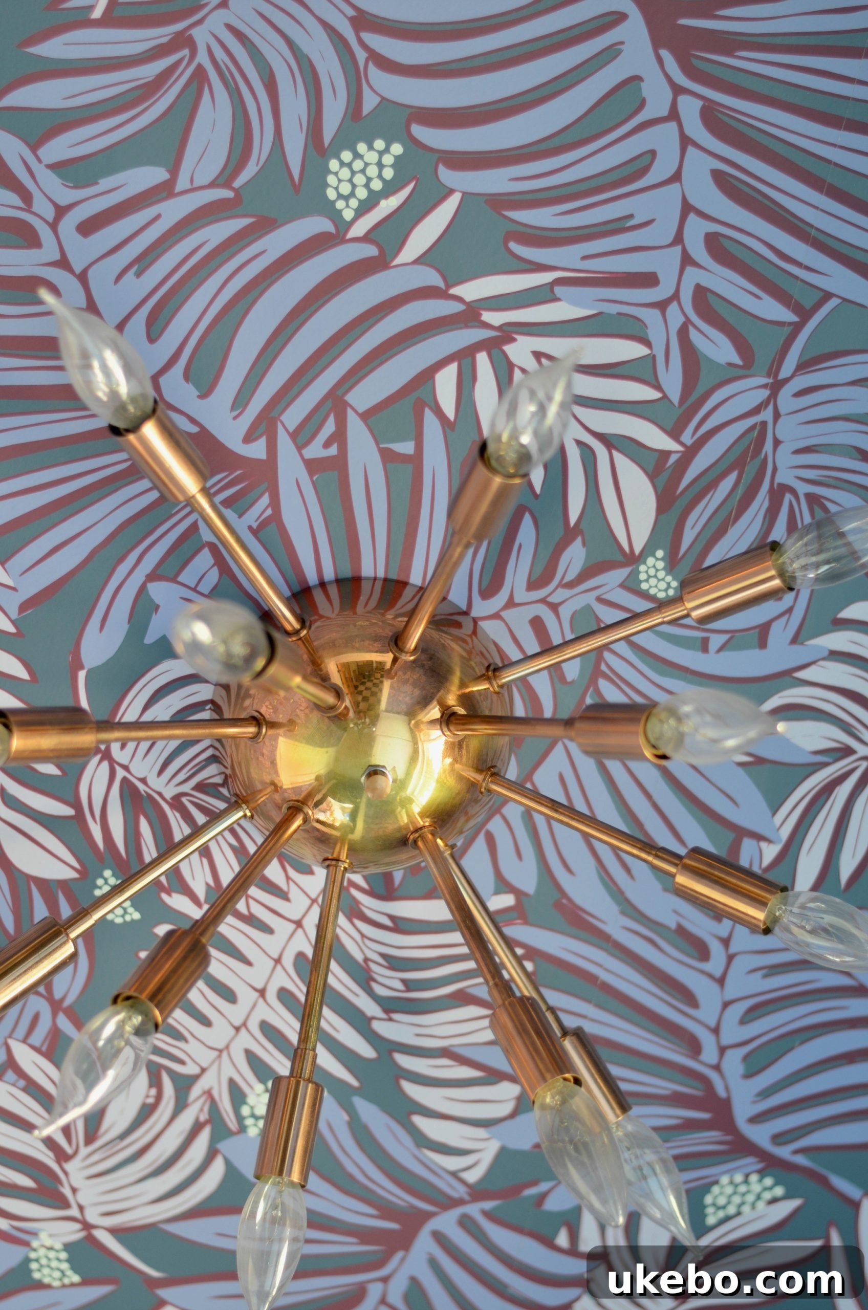Close-up of the new copper-accented chandelier and vibrant wallpaper in the laundry room.