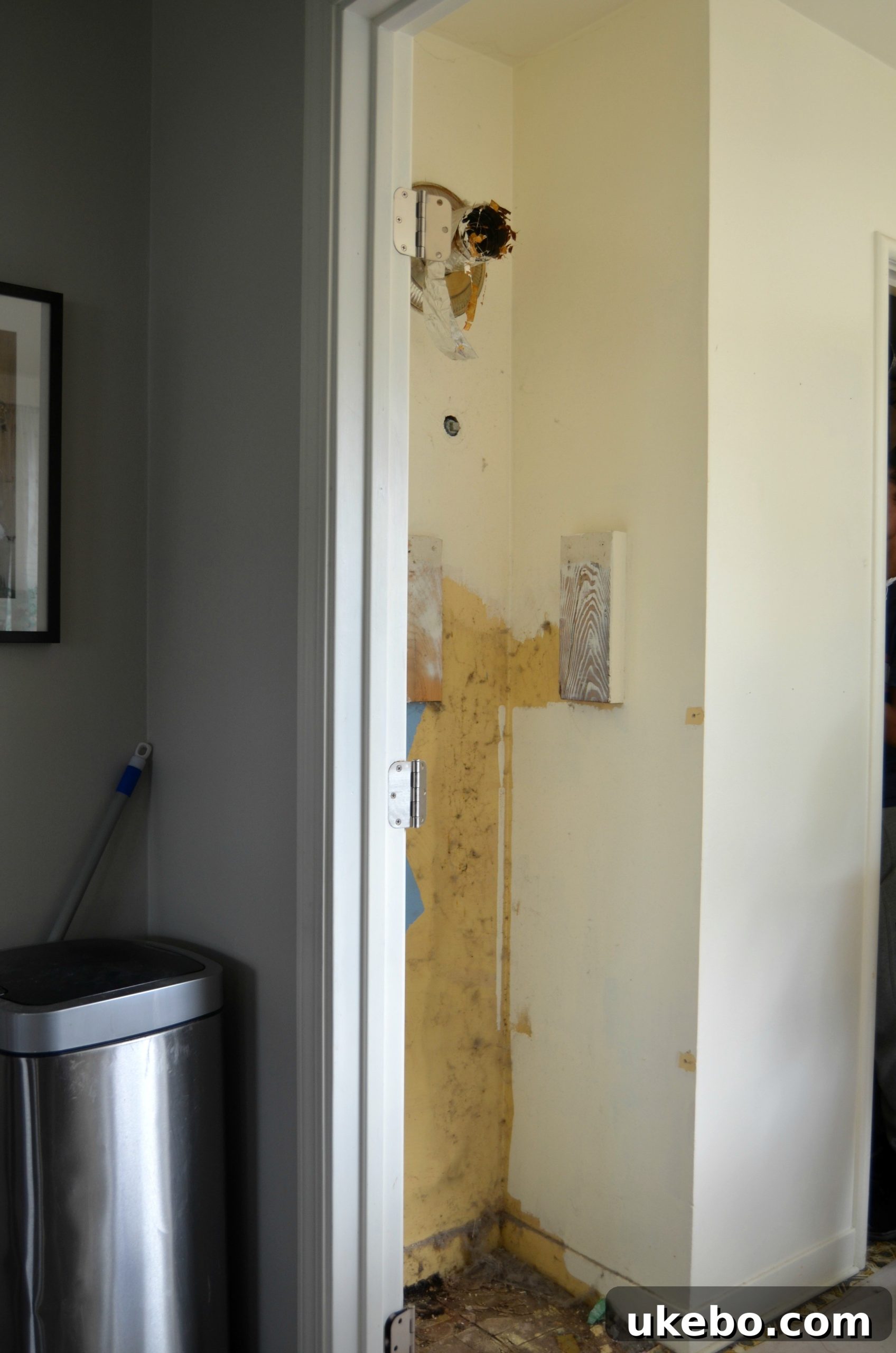 Laundry room after tankless water heater installation, showing more open space and clean walls.