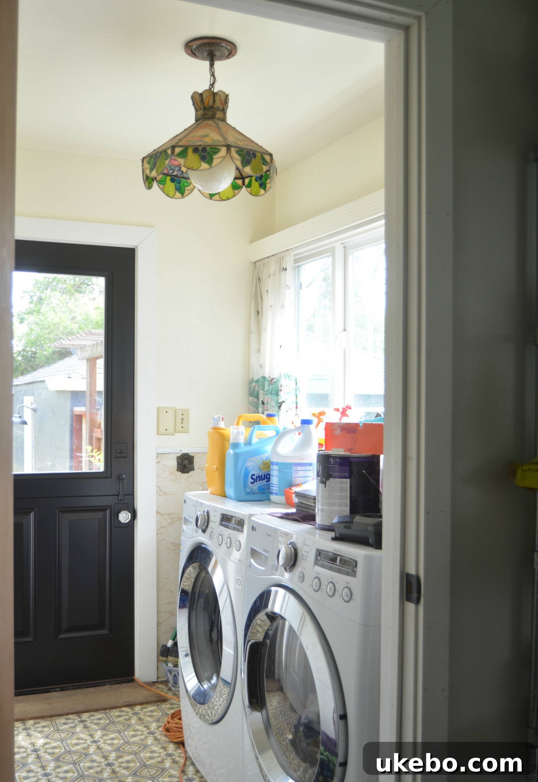 Newly installed Dutch door leading to the backyard, bringing character and light to the laundry room.