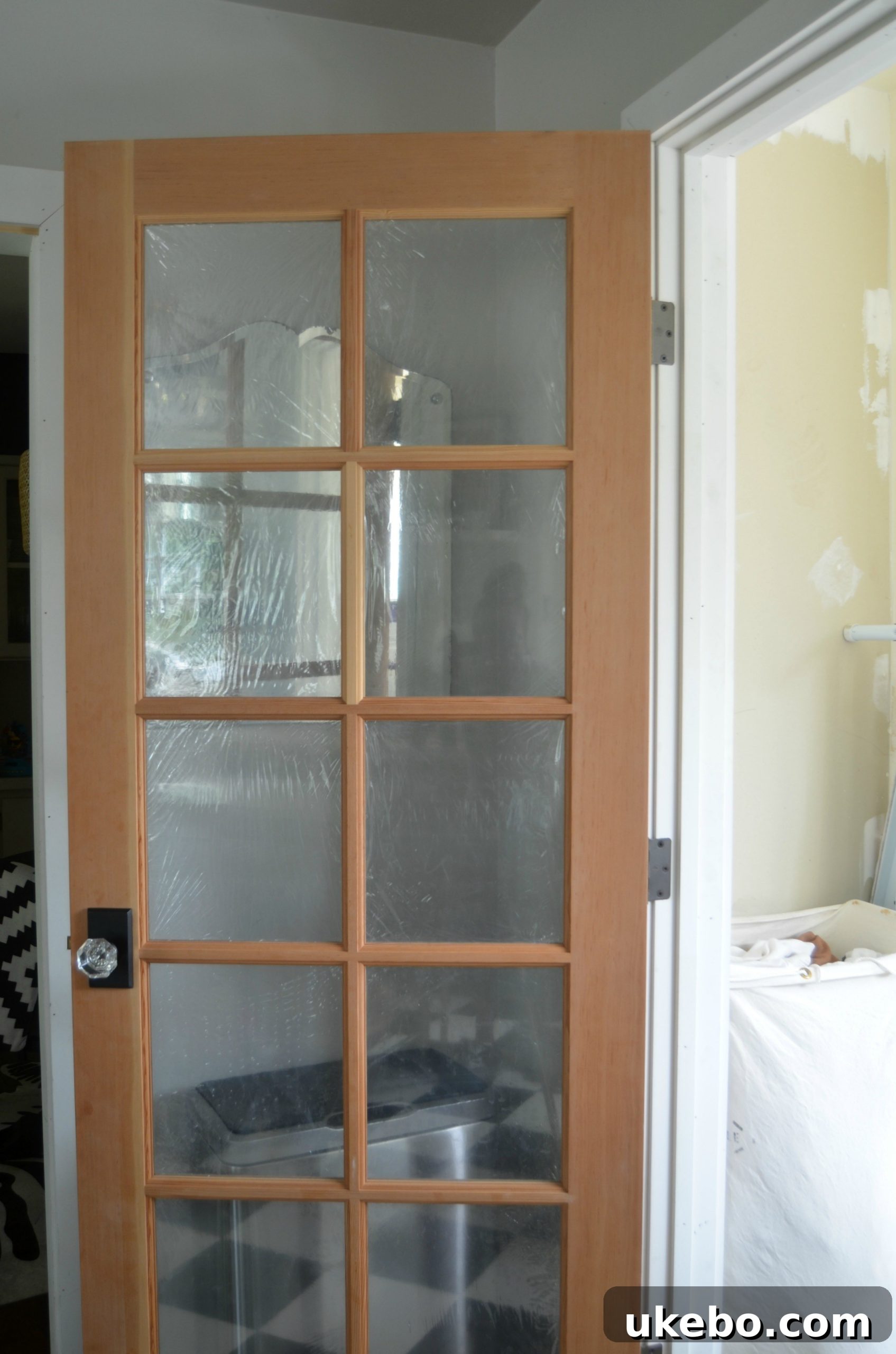 French doors installed between the laundry room and kitchen, enhancing light and open feel.