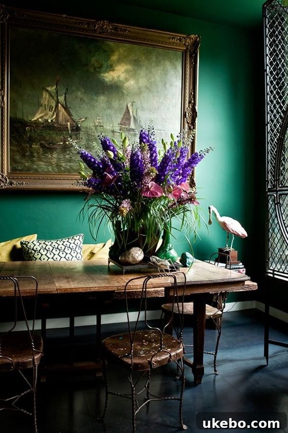 Elegant dining setting with dark walls and an ornate chandelier.