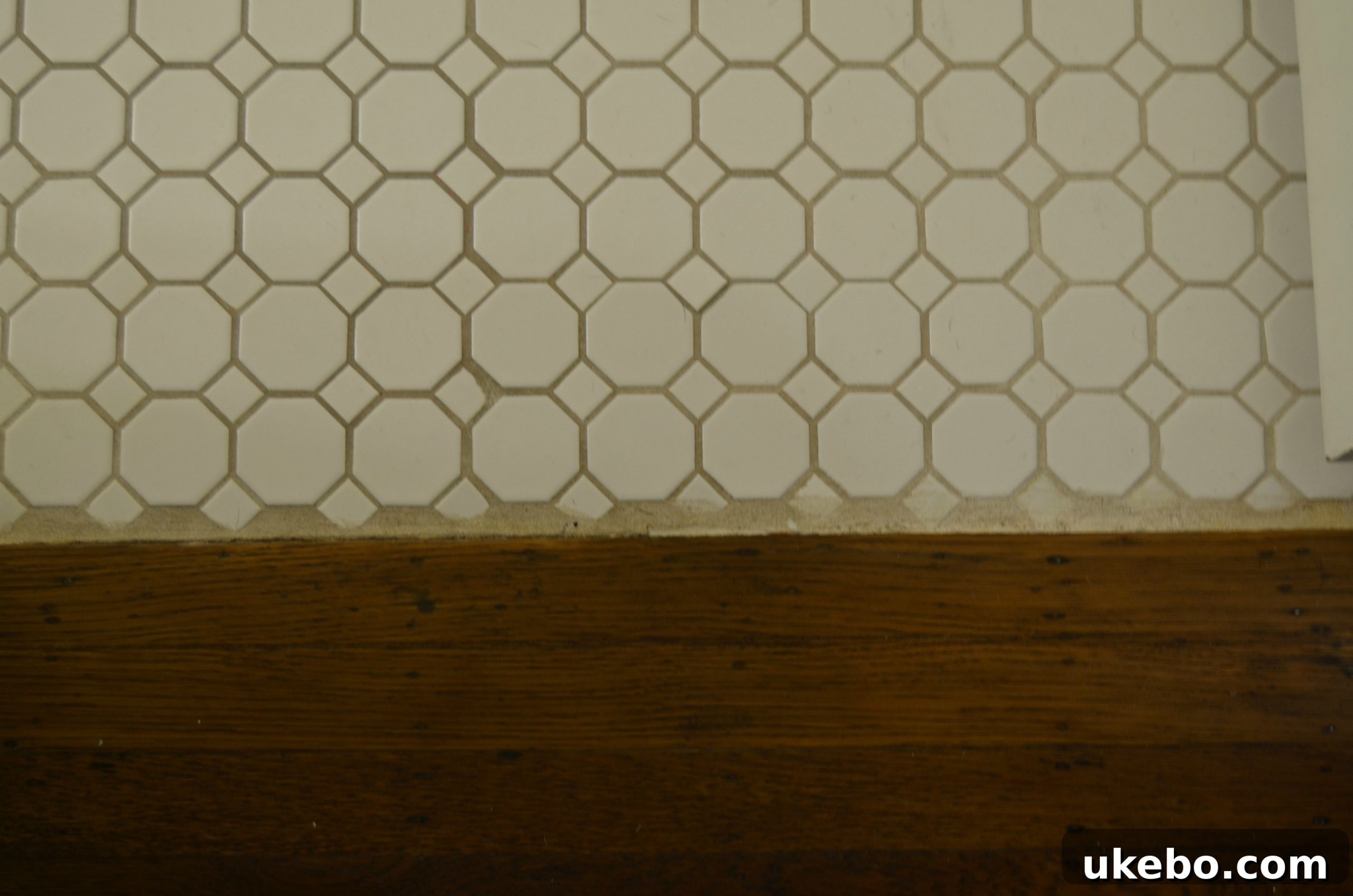 One Room Challenge Week 1 The Design Blueprint 9 Detail shot of uneven floor tiles and poorly applied grout in the bathroom