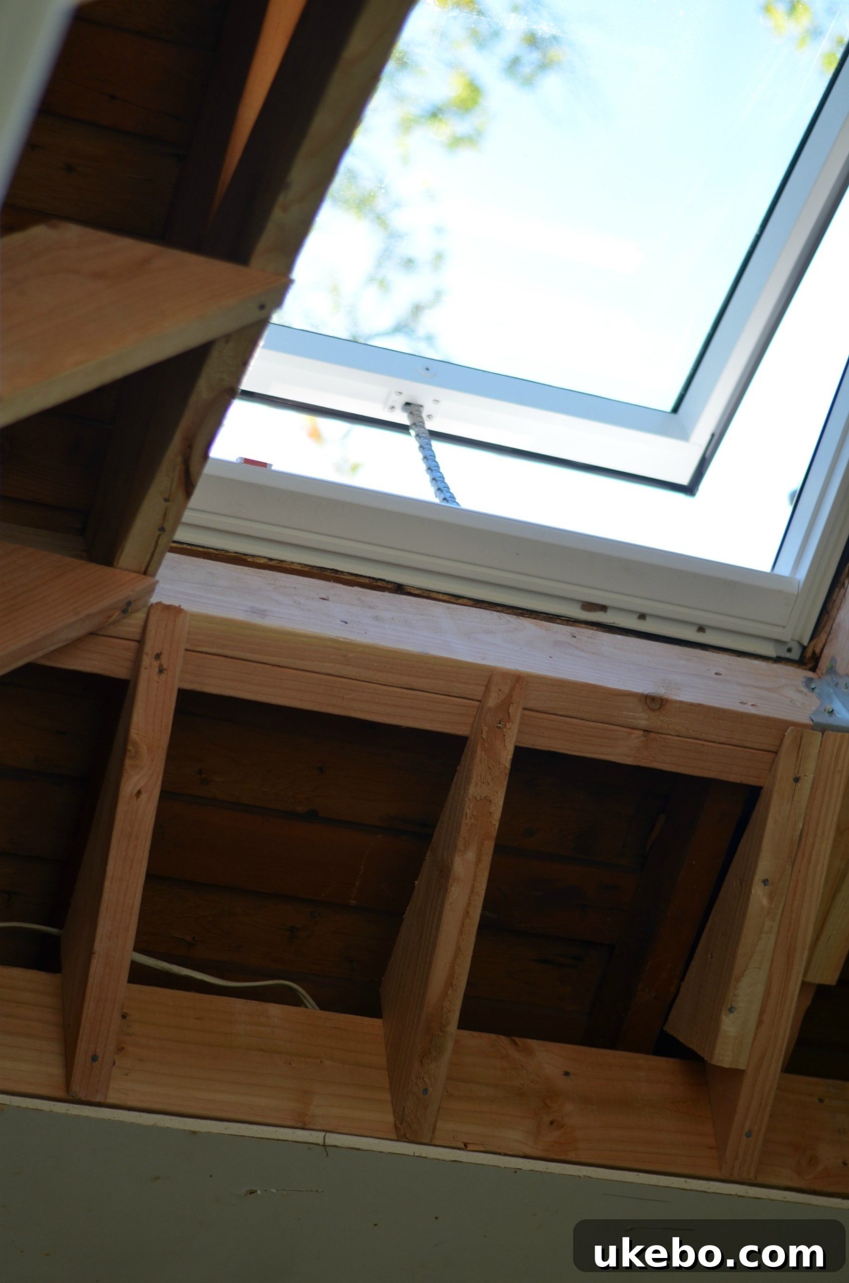 A detailed shot of the newly installed Velux skylight from inside the bathroom, emphasizing the quality of light and the sleek finish.