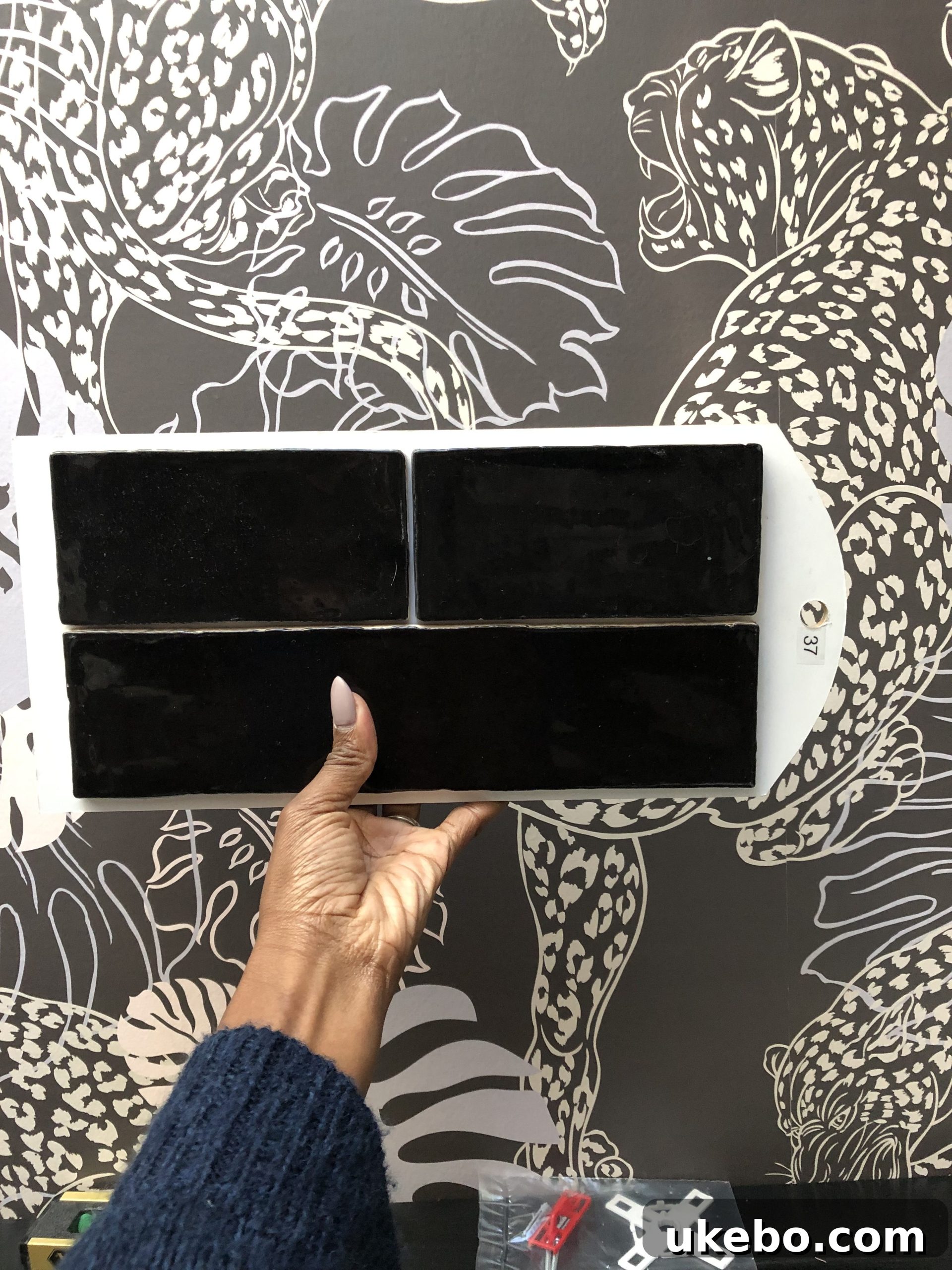 Sample of elongated black hand-scraped subway tile