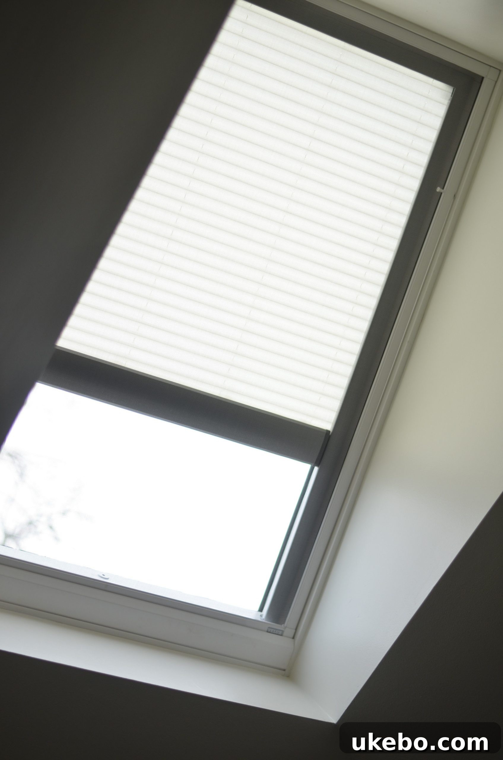 The automated skylight blind fully open, showcasing the brightness and design integration.