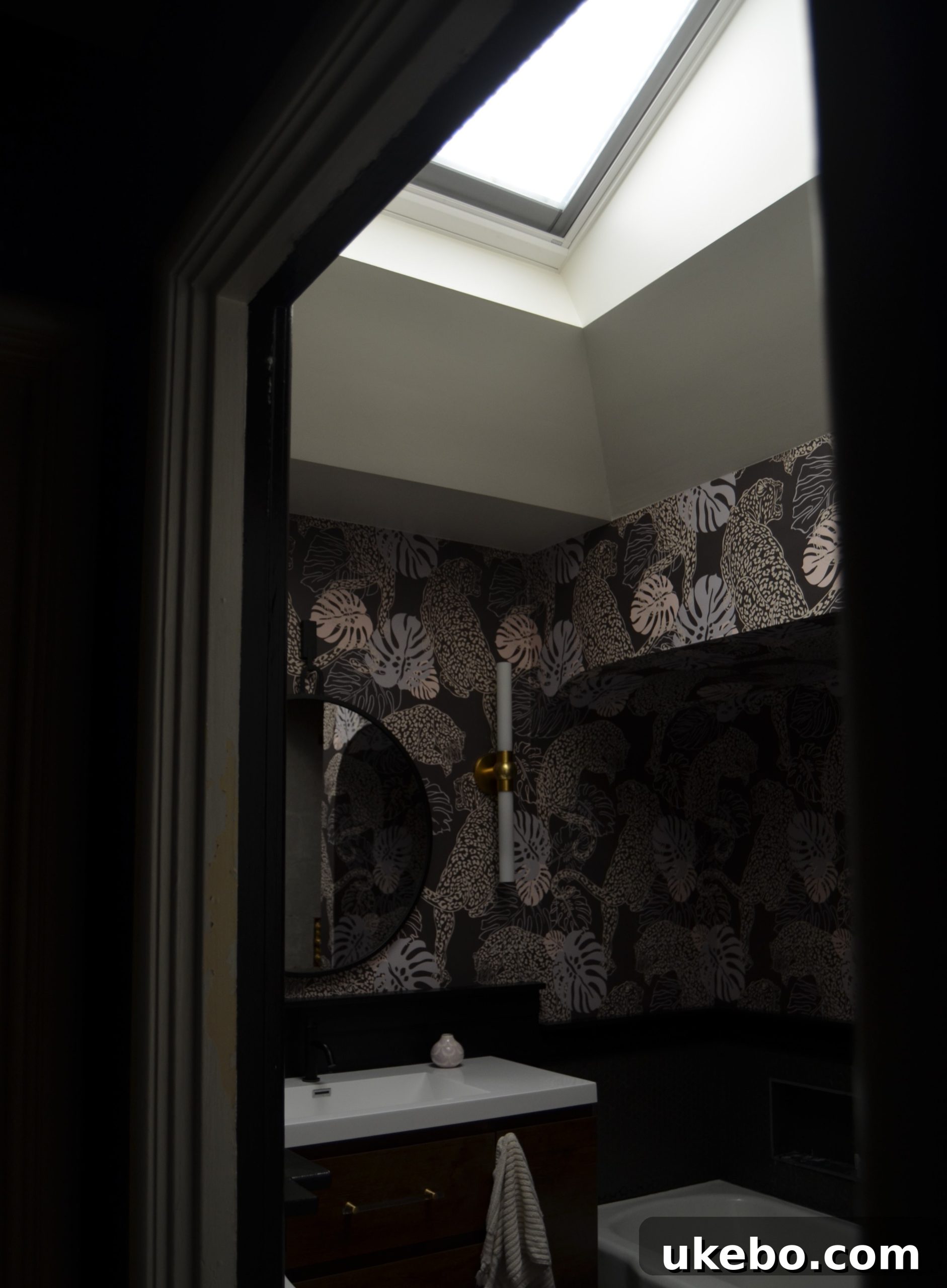 Bathroom interior in early morning with skylight blind closed, showing soft, filtered light.