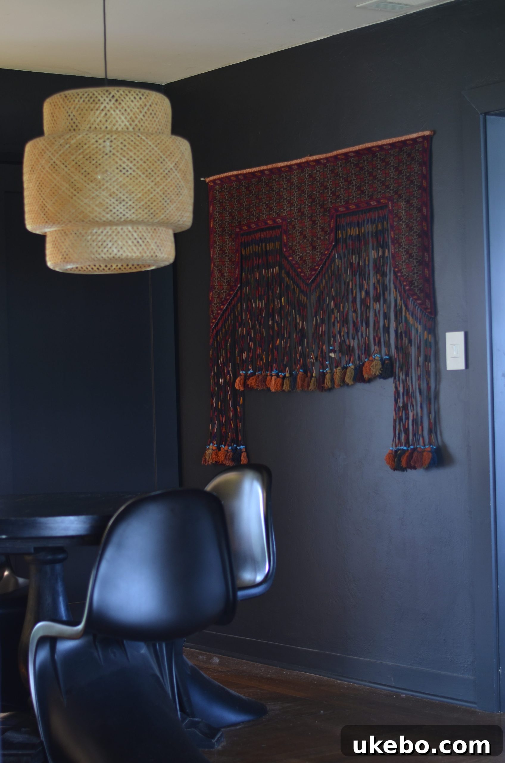 Close-up of previous dining room wall decor, including a small round mirror and framed art