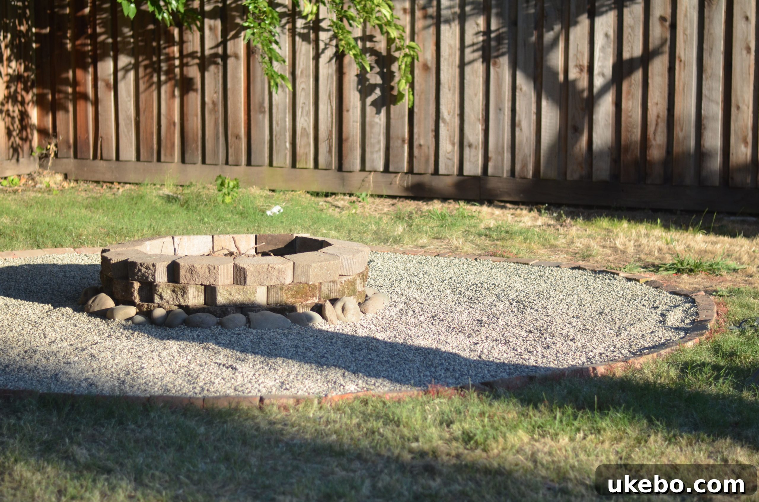 Crafting Your Perfect Summer Outdoor Oasis with POLYWOOD 12 Newly constructed fire pit area with decorative rocks and pavers