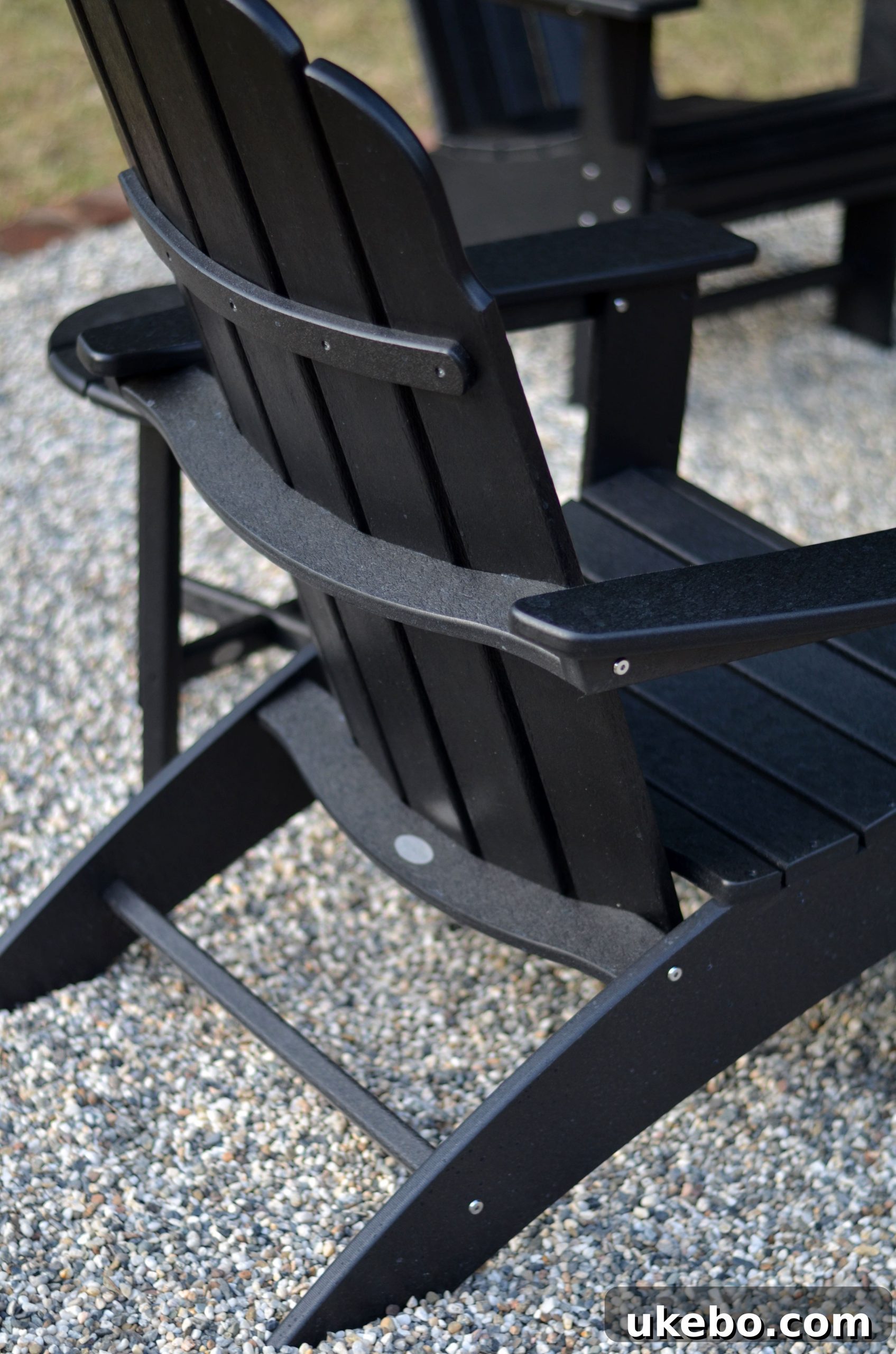 Family enjoying the comfortable POLYWOOD Adirondack chairs around the fire pit