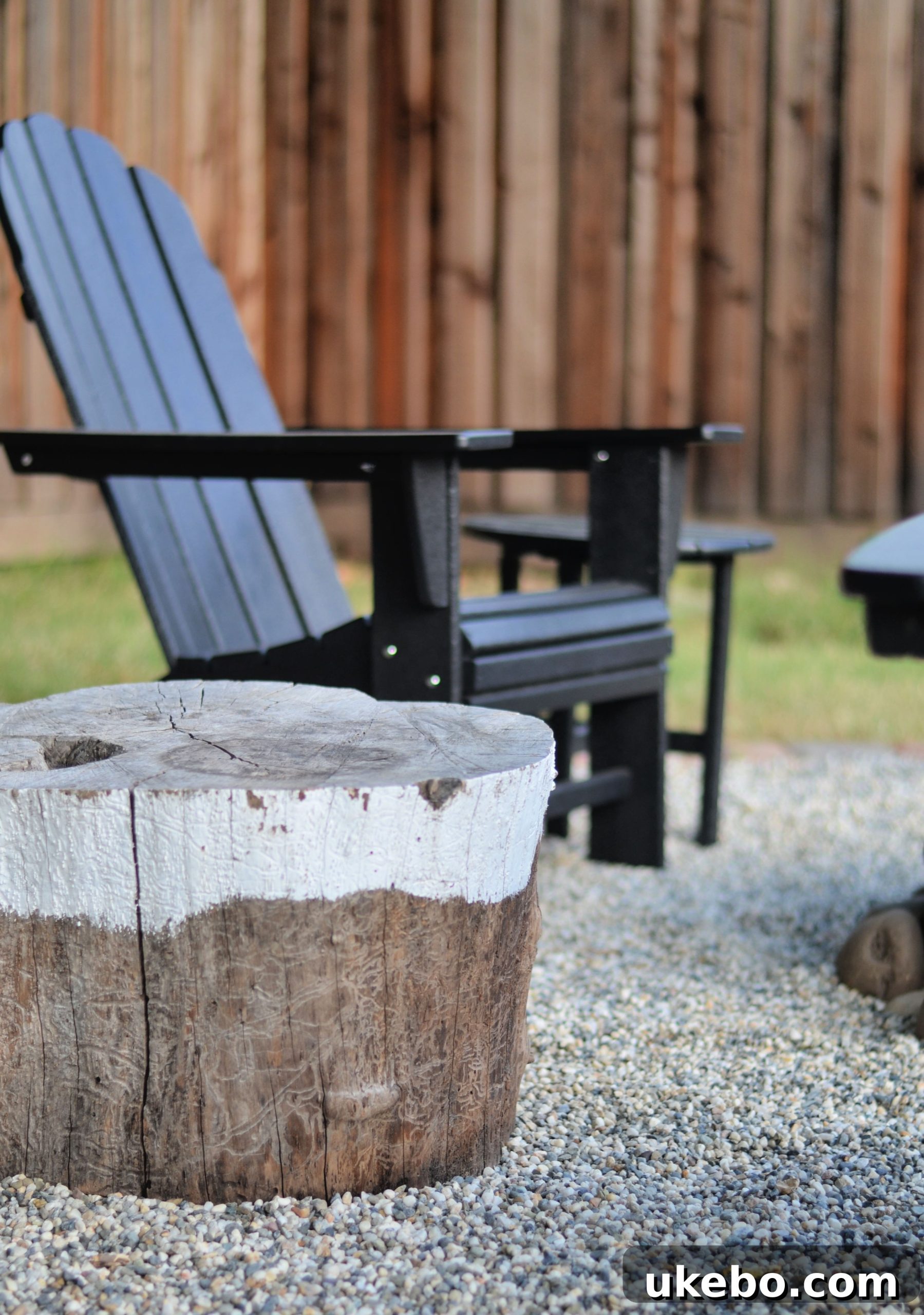 Crafting Your Perfect Summer Outdoor Oasis with POLYWOOD 22 Styled fire pit area with painted log seating and soft textiles